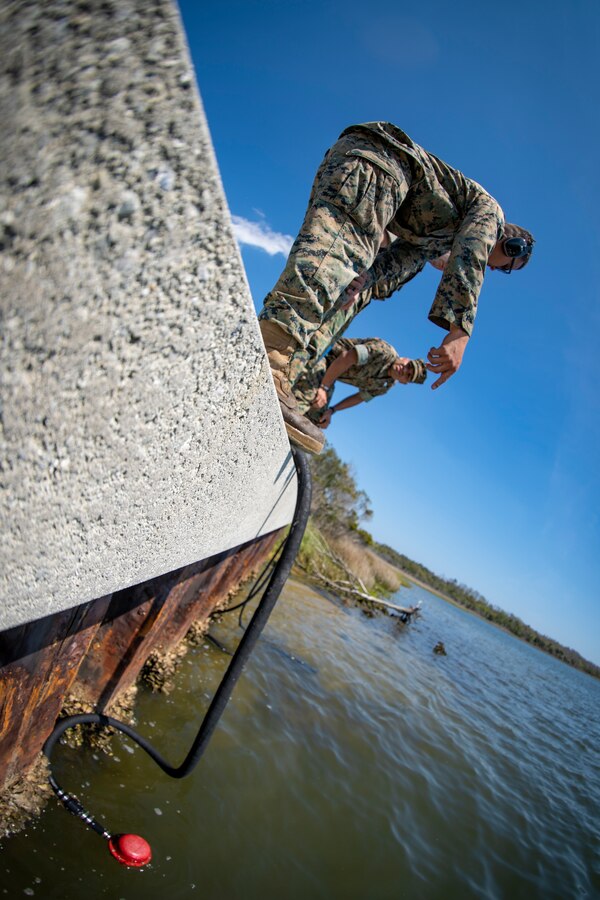 Lance Cpl. Joseph Sacco, a water support technician with Special Purpose Marine Air-Ground Task Force - Southern Command, explains the process of a lightweight water purification system during a command post exercise at Camp Lejeune, North Carolina, April 8, 2020. Water support technician Marines used lightweight water purification systems to purify water before providing it to the combat engineer Marines working at another site. The CPX increases readiness and challenges SPMAGTF-SC command and control, communications and timely decision-making capabilities through simulated real-world scenarios. SPMAGTF-SC will be deployed into the Southern Command area of operation to provide crisis response preparedness efforts, security cooperation training and engineering events to help strengthen relations with partner nations throughout Central and South America. Sacco is a native of Beaverton, Oregon. (U.S. Marine Corps photo by Sgt. Andy O. Martinez)