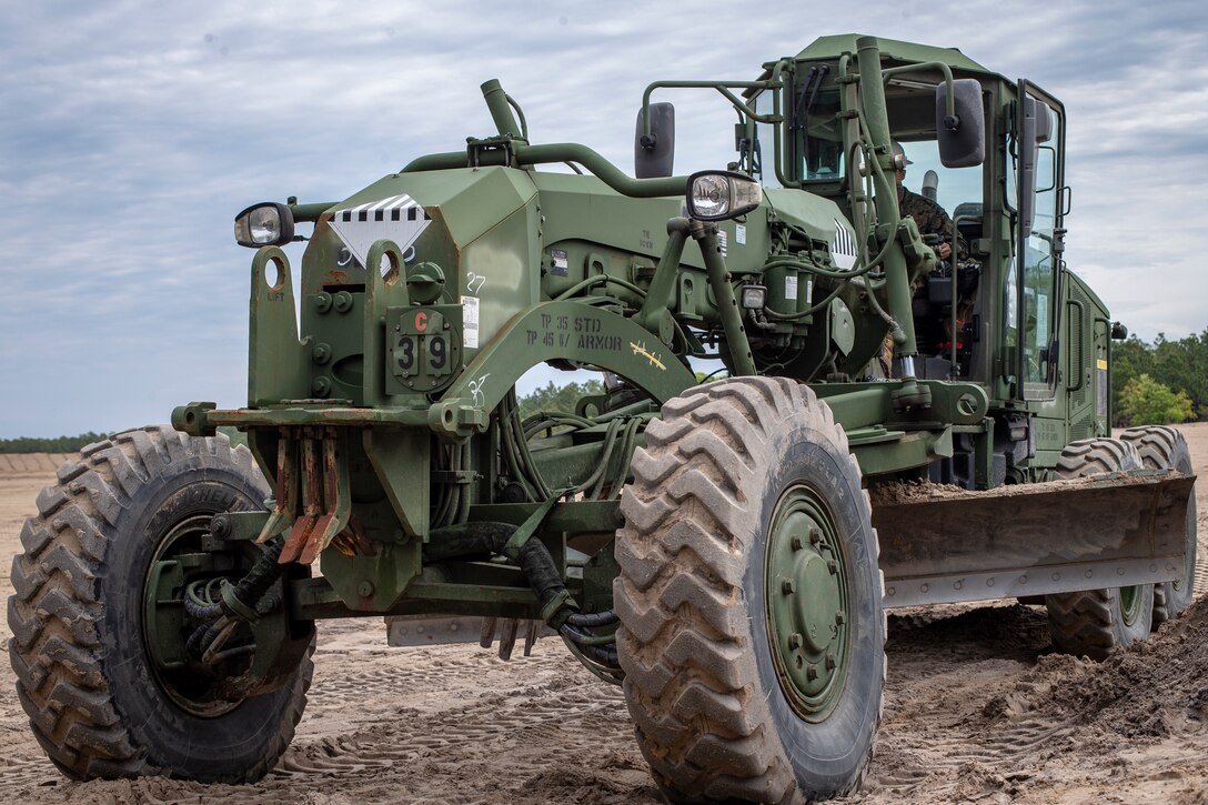 Lance Cpl. Ismael Renteria, a heavy equipment operator with Special Purpose Marine Air-Ground Task Force - Southern Command, operates a grader during a command post exercise at Marine Corps Base Camp Lejeune, North Carolina, April 9, 2020. Renteria was refueling the machine prior to parking it for the day. The Marines and Sailors of SPMAGTF-SC use the training opportunity of the CPX to both show their capabilities in a controlled environment and prepare for the upcoming mission. SPMAGTF-SC is poised to conduct crisis response, theater security cooperation, and general engineering training alongside partner nation militaries in Latin America and the Caribbean. Renteria is a native of Atwater, California. (U.S. Marine Corps photo by Cpl. Benjamin D. Larsen)