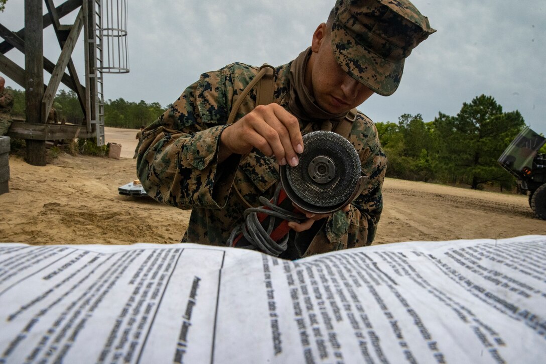 Lance Cpl. Ian Garcia, a combat engineer with Special Purpose Marine Air-Ground Task Force - Southern Command, gathers tools during a general exercise at Camp Lejeune, North Carolina, April 13, 2020. Combat engineer Marines are increasing their construction skills in preparation for infrastructure improvement projects scheduled during their upcoming deployment to Latin America. The GENEX includes training events such as engineering projects and evacuation control center training scenarios that will help build the SPMAGTF-SC for their final certification exercise. These training events also provide the Marines and Sailors with real-world scenarios to prepare them for their deployment to assist partner nation militaries in Latin America and the Caribbean. Garcia is a native of Wilsonville, Oregon. (U.S. Marine Corps photo by Sgt. Andy O. Martinez)