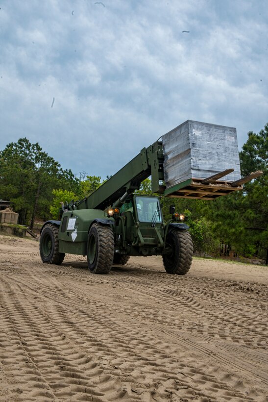 Cpl. Rainier Colina, a heavy equipment operator with Special Purpose Marine Air-Ground Task Force - Southern Command, delivers a pallet of concrete bricks during a general exercise at Camp Lejeune, North Carolina, April 13, 2020. Combat engineer Marines are increasing their construction skills in preparation for infrastructure improvement projects scheduled during their upcoming deployment to Latin America. The GENEX includes training events such as engineering projects and evacuation control center training scenarios that will help build the SPMAGTF-SC for their final certification exercise. These training events also provide the Marines and Sailors with real-world scenarios to prepare them for their deployment to assist partner nation militaries in Latin America and the Caribbean. Colina is a native of Livingston, California. (U.S. Marine Corps photo by Sgt. Andy O. Martinez)