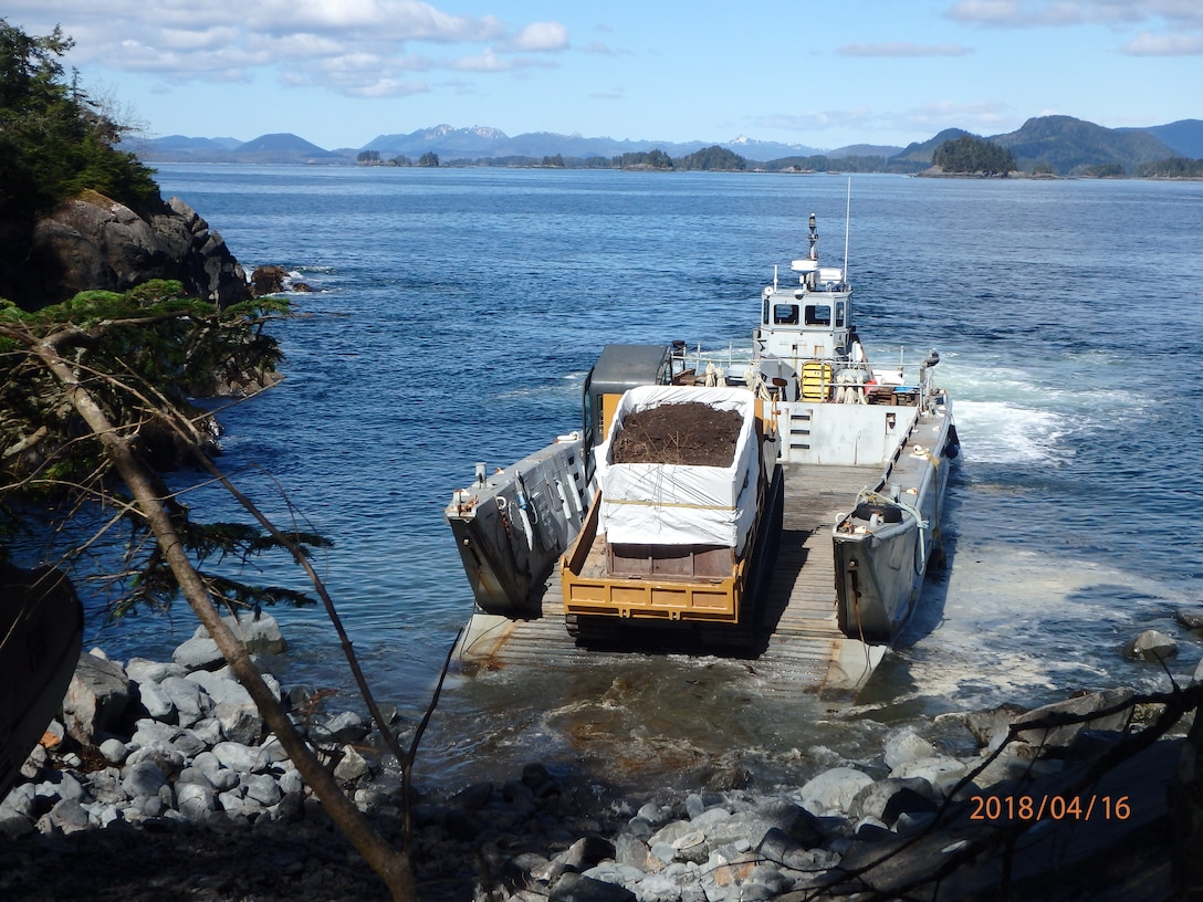 Beyond the immense amount of contamination at the landfill, one of the greatest challenges of the project was logistics while access is limited to marine vessels only. Shown here, a Marooka loaded with contaminated soil drives onto a landing craft at the historical park.