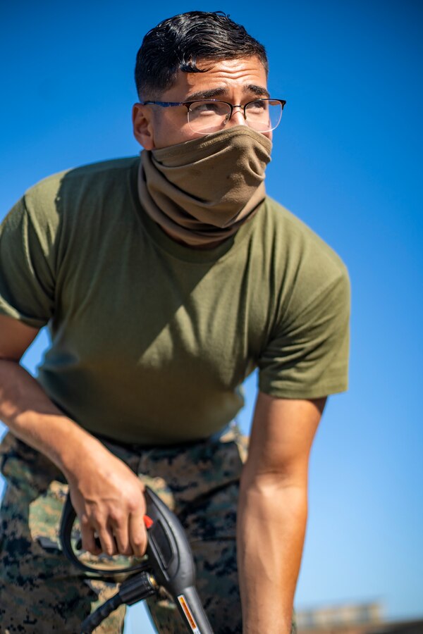 Lance Cpl. Manuel Flores, a refrigeration and air conditioning technician with Special Purpose Marine Air-Ground Task Force - Southern Command, operates a pressure washer during a general exercise at Camp Lejeune, North Carolina, April 14, 2020. The Marines removed dirt and debris from equipment to help minimize the risk of agricultural contamination before putting it into storage for future use. TThe GENEX includes training events such as engineering projects and evacuation control center training scenarios that will help build the SPMAGTF-SC for their final certification exercise. These training events also provide the Marines and Sailors with real-world scenarios to prepare them for their deployment to assist partner nation militaries in Latin America and the Caribbean. Flores is a native of Fort Worth, Texas. (U.S. Marine Corps photo by Sgt. Andy O. Martinez)