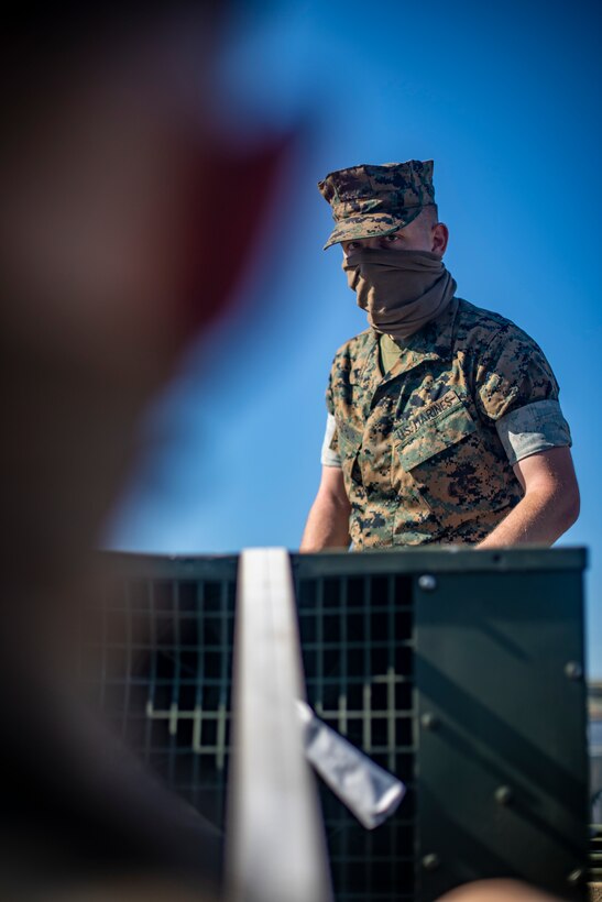 Cpl. Gennadiy Tkachuk, an engineer equipment electrical systems technician with Special Purpose Marine Air-Ground Task Force - Southern Command, ties down equipment with a strap during a general exercise at Camp Lejeune, North Carolina, April 14, 2020. The GENEX includes training events such as engineering projects and evacuation control center training scenarios that will help build the SPMAGTF-SC for their final certification exercise. These training events also provide the Marines and Sailors with real-world scenarios to prepare them for their deployment to assist partner nation militaries in Latin America and the Caribbean. Tkachuk is a native of Hillsboro, Oregon. (U.S. Marine Corps photo by Sgt. Andy O. Martinez)