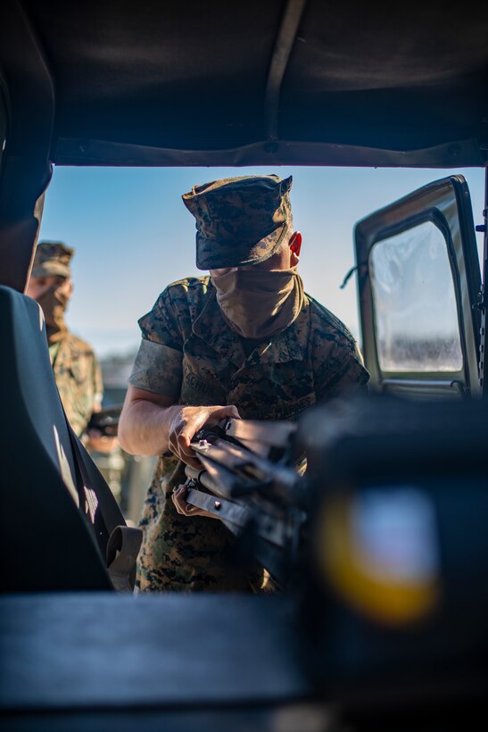 Cpl. Gennadiy Tkachuk, an engineer equipment electrical systems technician with Special Purpose Marine Air-Ground Task Force - Southern Command, places flood lights into a vehicle during a general exercise at Camp Lejeune, North Carolina, April 14, 2020. TThe GENEX includes training events such as engineering projects and evacuation control center training scenarios that will help build the SPMAGTF-SC for their final certification exercise. These training events also provide the Marines and Sailors with real-world scenarios to prepare them for their deployment to assist partner nation militaries in Latin America and the Caribbean. Tkachuk is a native of Hillsboro, Oregon. (U.S. Marine Corps photo by Sgt. Andy O. Martinez)