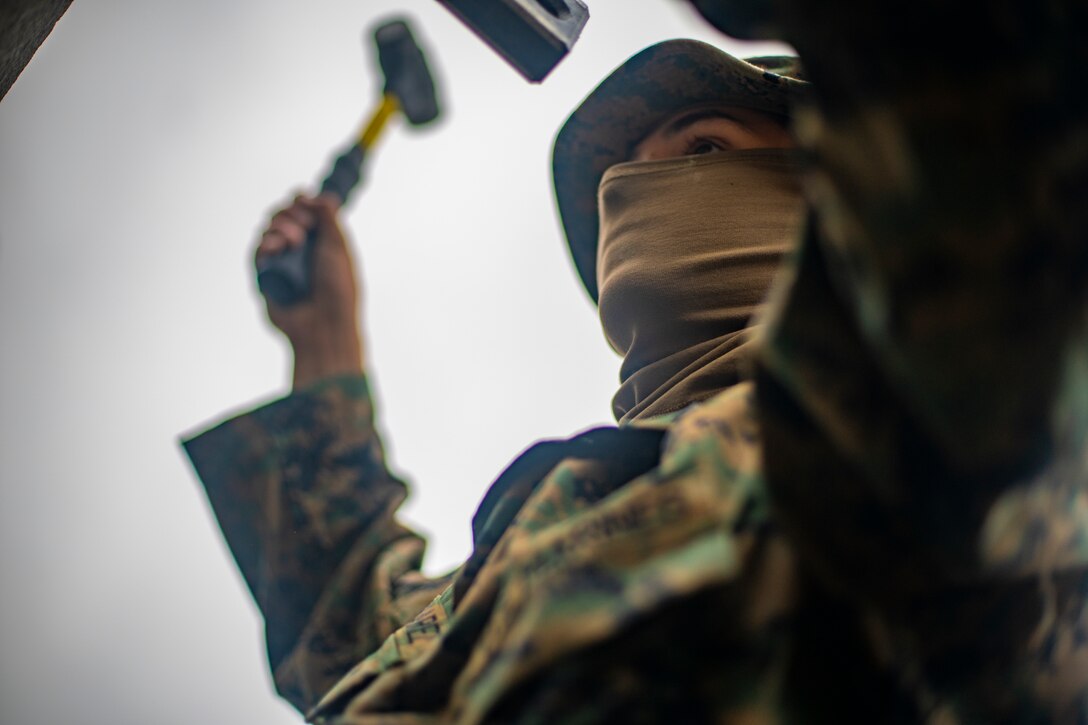 Lance Cpl. Christopher Alvarez, a combat engineer with Special Purpose Marine Air-Ground Task Force - Southern Command, levels a concrete brick during a general exercise at Camp Lejeune, North Carolina, April 15, 2020. Combat engineer Marines are increasing their construction skills in preparation for infrastructure improvement projects scheduled during their upcoming deployment to Latin America. The GENEX includes training events such as engineering projects and evacuation control center training scenarios that will help build the SPMAGTF-SC for their final certification exercise. These training events also provide the Marines and Sailors with real-world scenarios to prepare them for their deployment to assist partner nation militaries in Latin America and the Caribbean. Alvarez is a native of Portland, Oregon. (U.S. Marine Corps photo by Sgt. Andy O. Martinez)