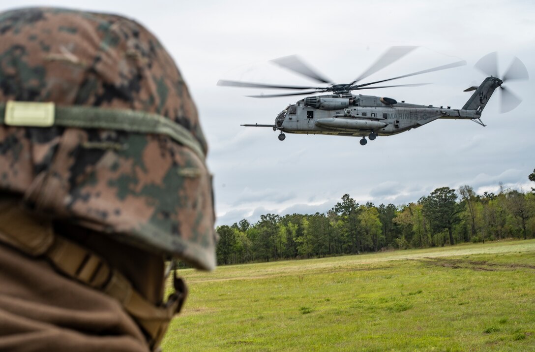 Marines and Sailors with Special Purpose Marine Air-Ground Task Force - Southern Command wait to board a CH-53E Super Stallion helicopter for transportation to evacuation control center training during a general exercise at Camp Lejeune, North Carolina, April 15, 2020. The GENEX includes training events such as engineering projects and evacuation control center training scenarios that will help build the SPMAGTF-SC for their final certification exercise. These training events also provide the Marines and Sailors with real-world scenarios to prepare them for their deployment to assist partner nation militaries in Latin America and the Caribbean. (U.S. Marine Corps photo by Sgt. Andy O. Martinez)