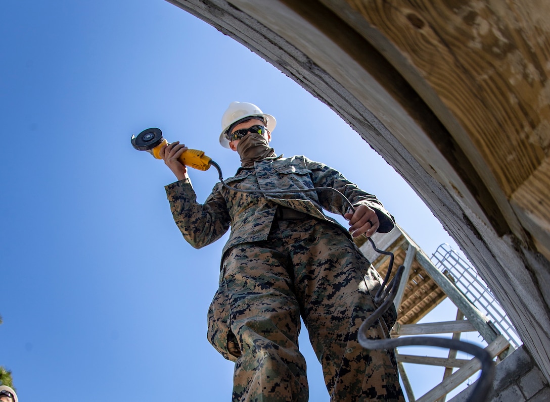 Lance Cpl. Tyler Alexander, a combat engineer with Special Purpose Marine Air-Ground Task Force - Southern Command, prepares to grind rebar during a general exercise at Marine Corps Base Camp Lejeune, North Carolina, April 16, 2020. Combat engineer Marines are increasing their construction skills in preparation for infrastructure improvement projects scheduled during their upcoming deployment to Latin America. The GENEX includes training events such as engineering projects and evacuation control center training scenarios that will help build the SPMAGTF-SC for their final certification exercise. These training events also provide the Marines and Sailors with real-world scenarios to prepare them for their deployment to assist partner nation militaries in Latin America and the Caribbean.  Alexander is a native of Scappoose, Oregon. (U.S. Marine Corps photo by Cpl. Benjamin D. Larsen)