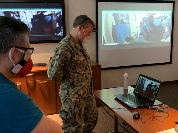 Capt. John Markowicz, assistant chief of staff for ship maintenance and material readiness, Commander, Naval Air Forces, observes the Distance Communications Maintenance System (DCoMS) ship-to-shore test between the Naval Information Warfare Center Pacific and USS Ronald Reagan (CVN 76), while the aircraft carrier was underway in the Indo-Pacific region. DCoMS allows shore-based technical experts to remotely walk shipboard technicians through a higher level of maintenance or troubleshooting than the technician would normally have the capability to perform.