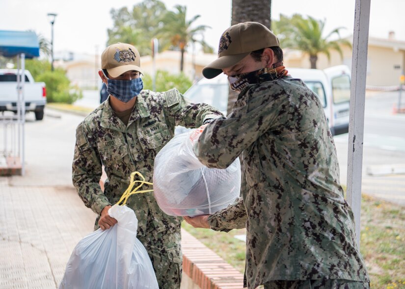 Sailors handing out donations.