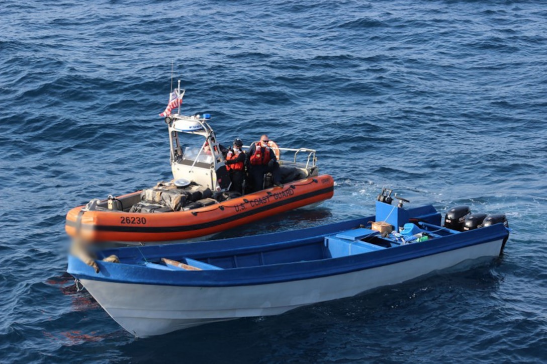 Members of the Coast Guard Cutter Active boarding team inspect a suspected smuggling vessel.