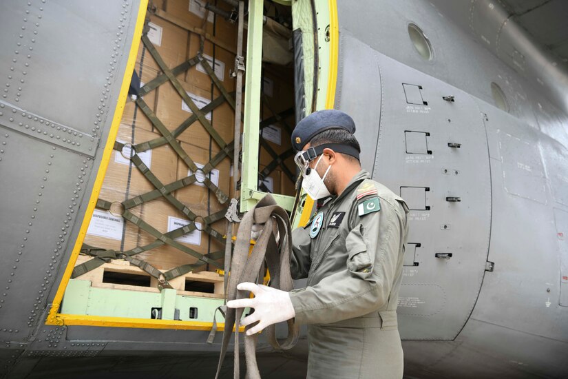 A Pakistani aircrew member gathers straps off a Pakistan air force C-130 at Joint Base Andrews, Md., May 21, 2020. During the event, Ambassador Asad Majeed Khan, an official from the Pakistani Embassy, highlighted the historic ties between the people of the U.S. and Pakistan and their armed forces. Khan also noted the armed forces of both countries have fought together in the Global War on Terrorism and stand together in the fight against the COVID-19 pandemic. (U.S. Air Force photo by Airman 1st Class Spencer Slocum)