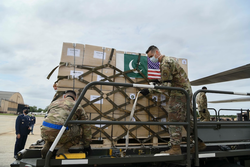 89th Airlift Wing Airmen unload a Pakistan air force C-130 at Joint Base Andrews, Md., May 21, 2020. The donated materials were sent to the Federal Emergency Management Agency in support of the fight against COVID-19. (U.S. Air Force photo by Airman 1st Class Spencer Slocum)