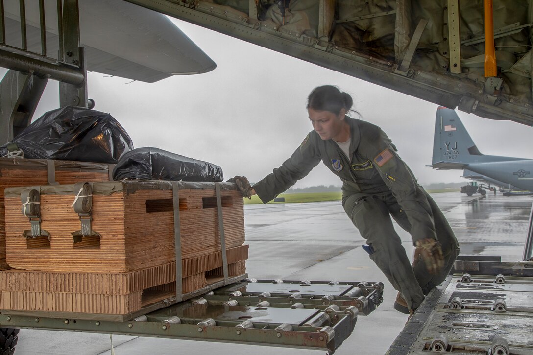 Staff Sgt. Sarah Meadows, 36th Airlift Squadron C-130J loadmaster, loads a low-cost, low-altitude bundle onto a C-130J Super Hercules at Yokota Air Base, Japan, May 21, 2020, during the Samurai Surge training exercise.