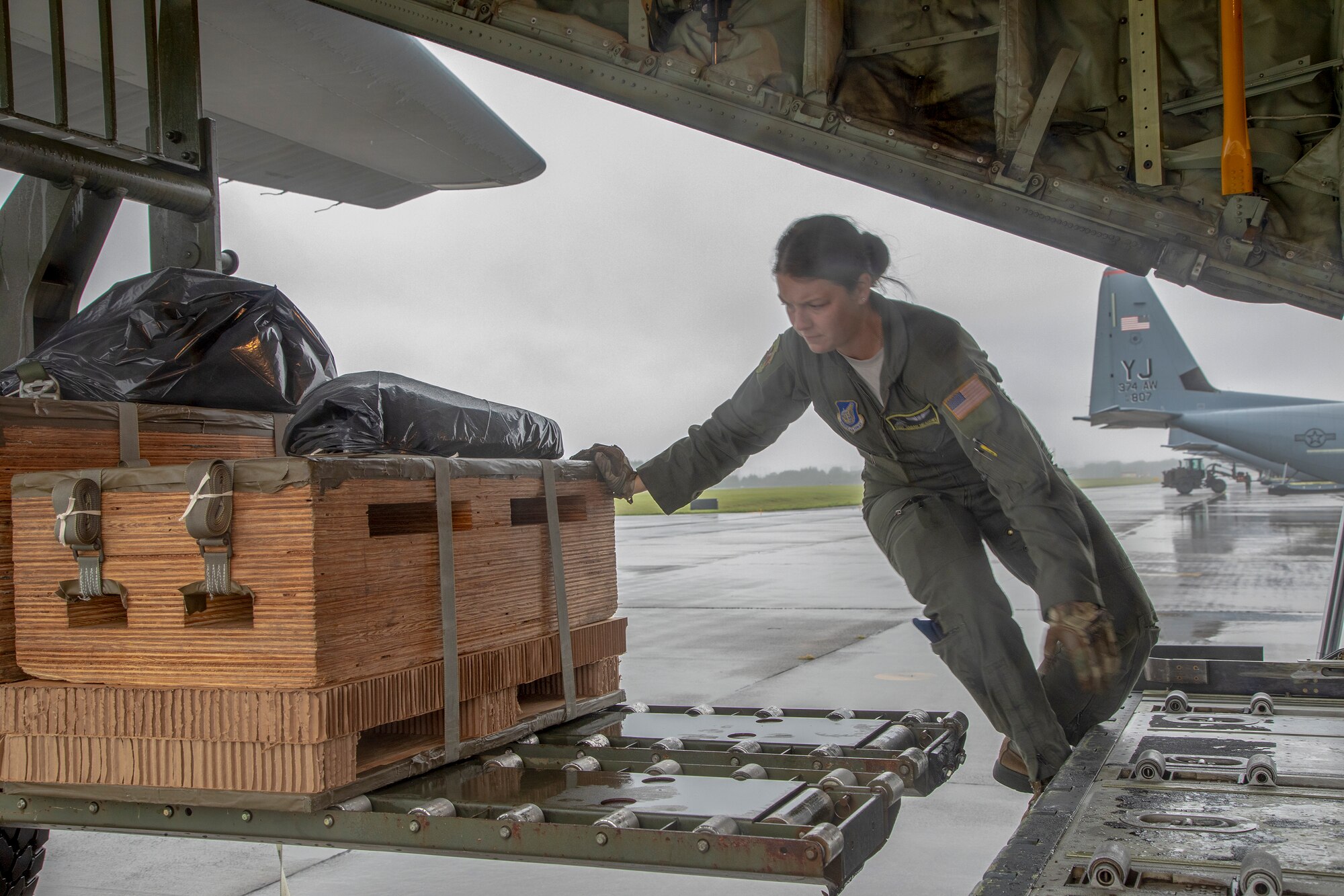 Staff Sgt. Sarah Meadows, 36th Airlift Squadron C-130J loadmaster, loads a low-cost, low-altitude bundle onto a C-130J Super Hercules at Yokota Air Base, Japan, May 21, 2020, during the Samurai Surge training exercise.