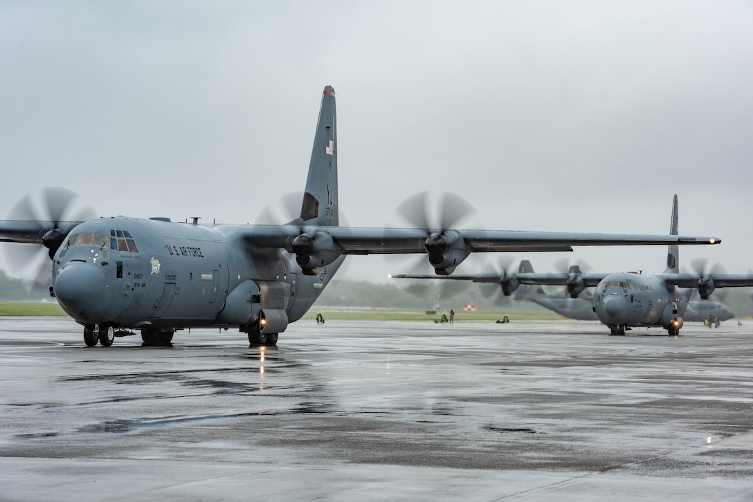 Two C-130J Super Hercules with the 36th Airlift Squadron taxi on the flight line during the elephant walk portion of the Samurai Surge training exercise, May 21, 2020, at Yokota Air Base, Japan.