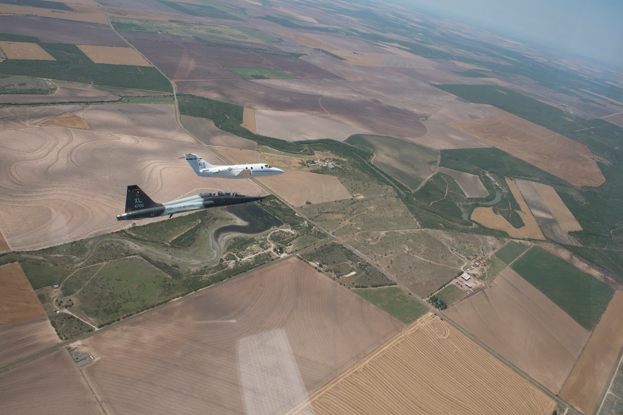 A T-6 Texan II, T-1A Jayhawk and a T-38C Talon, assigned to Laughlin Air Force Base, Texas, perform a flyover in San Angelo, Texas, May 21, 2020. Laughlin performed flyovers in three Texas cities as a part of the America Strong America Salutes Campaign, to show its gratitude for all front-line responders, economy sustainers and community members in the COVID-19 pandemic. (U.S. Air Force photo by Staff Sgt. Benjamin N. Valmoja)