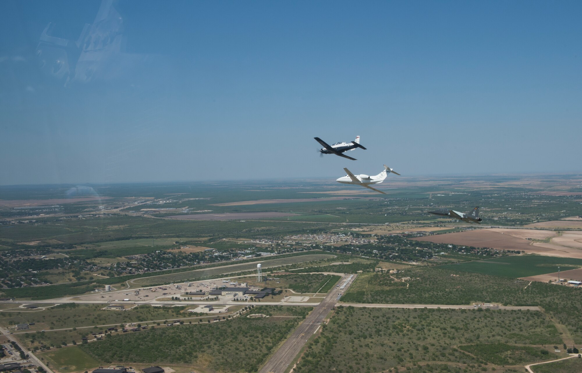 A T-6 Texan II, T-1A Jayhawk and a T-38C Talon, assigned to Laughlin Air Force Base, Texas, perform a flyover in San Angelo, Texas, May 21, 2020. Laughlin performed flyovers in three Texas cities as a part of the America Strong America Salutes Campaign, to show its gratitude for all front-line responders, economy sustainers and community members in the COVID-19 pandemic. (U.S. Air Force photo by Staff Sgt. Benjamin N. Valmoja)