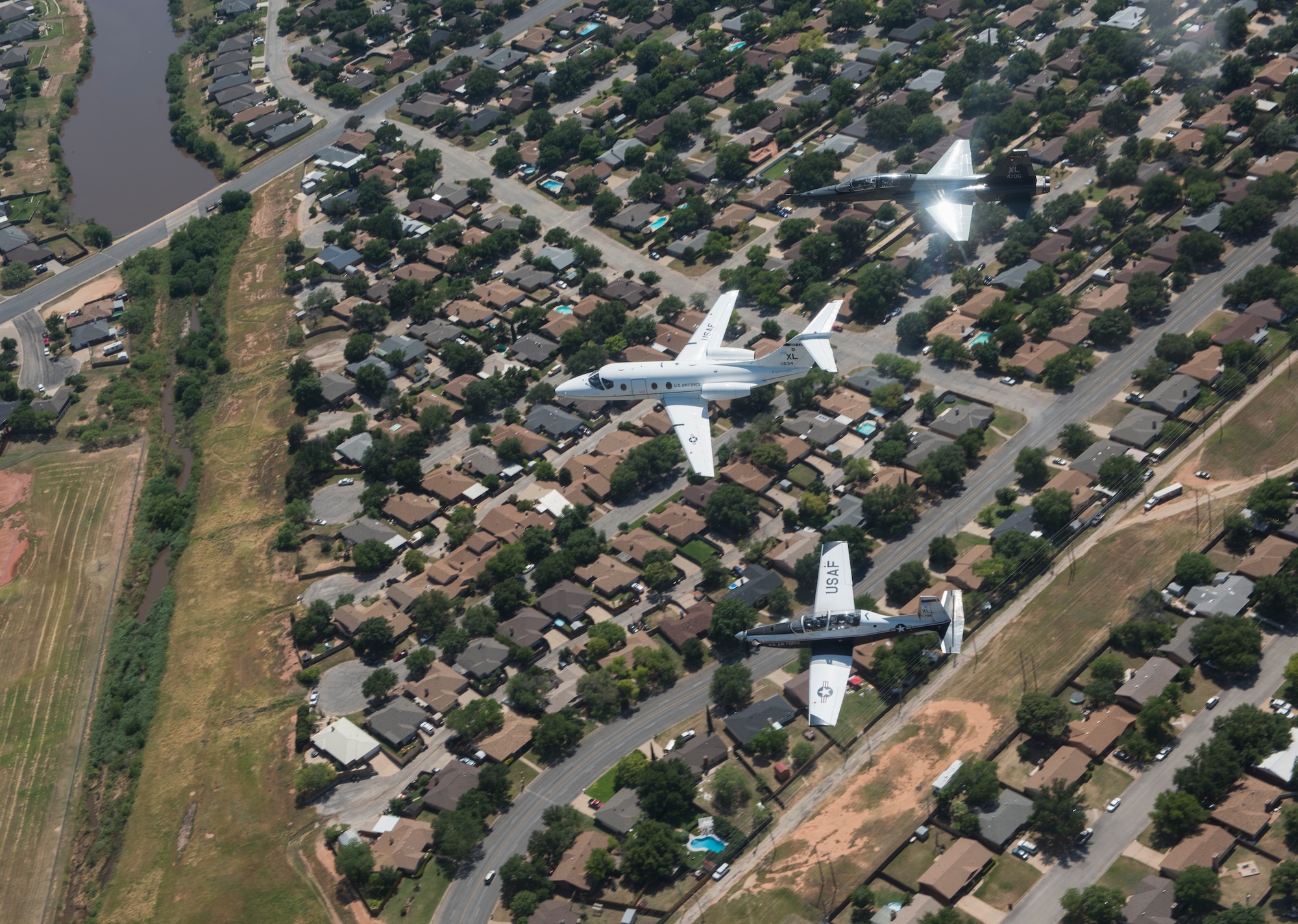 A T-6 Texan II, T-1A Jayhawk and a T-38C Talon, assigned to Laughlin Air Force Base, Texas, perform a flyover in San Angelo, Texas, May 21, 2020. Laughlin performed flyovers in three Texas cities as a part of the America Strong America Salutes Campaign, to show its gratitude for all front-line responders, economy sustainers and community members in the COVID-19 pandemic. (U.S. Air Force photo by Staff Sgt. Benjamin N. Valmoja)