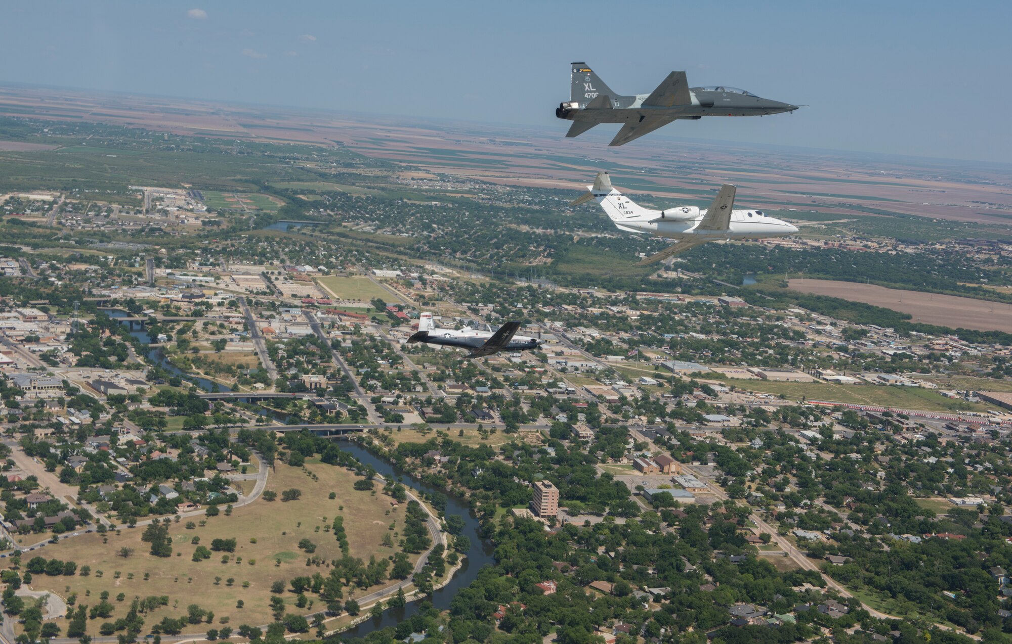 A T-6 Texan II, T-1A Jayhawk and a T-38C Talon, assigned to Laughlin Air Force Base, Texas, perform a flyover in San Angelo, Texas, May 21, 2020. Laughlin performed flyovers in three Texas cities as a part of the America Strong America Salutes Campaign, to show its gratitude for all front-line responders, economy sustainers and community members in the COVID-19 pandemic. (U.S. Air Force photo by Staff Sgt. Benjamin N. Valmoja)