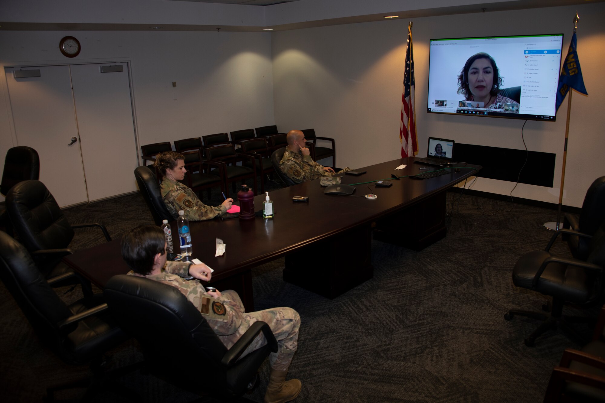 U.S. Air Force Master Sgt. Eric Wiltz, front left, 60th Contracting Squadron contracting officer, Staff Sgt. Amanda Jardine, center, 60th CONS contracting officer, and Tech. Sgt. Gage Bergman, right, 60th CONS contracting officer, listen to a presentation May 20, 2020, during a commercial solutions opening event at Travis Air Force Base, California. The event provided five companies an opportunity to present innovative solutions to enhance the mission at Travis AFB. (U.S. Air Force photo by Tech. Sgt. James Hodgman)