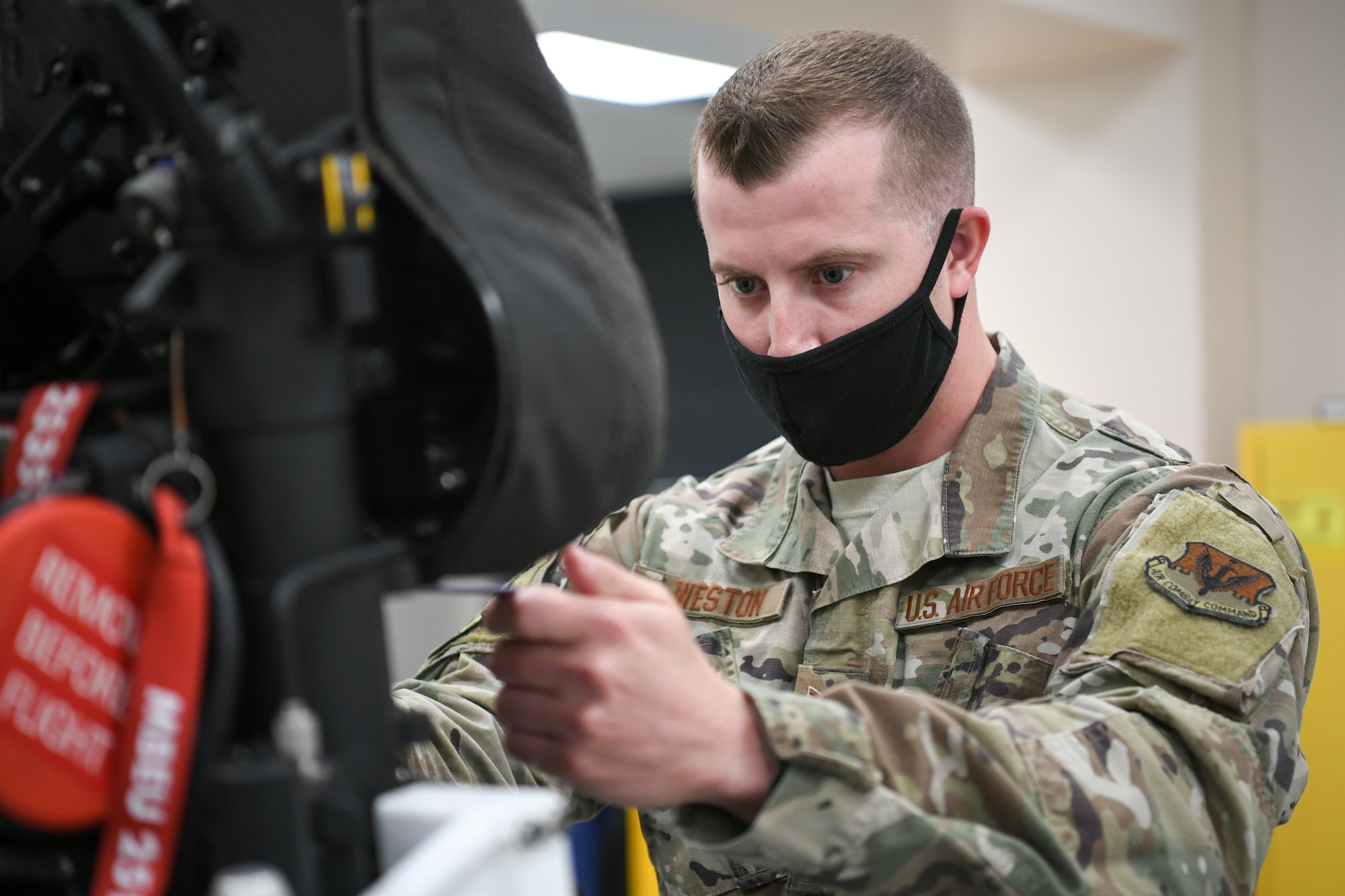 A photo of Staff Sgt. Cameron Westin working on an F-35A ejection seat