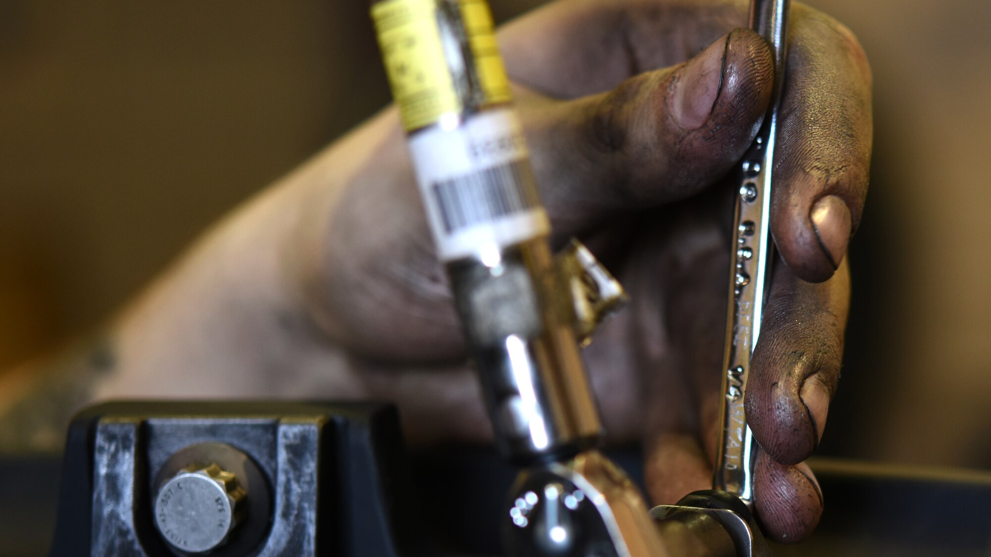 A photo of an Airman working working with tools.