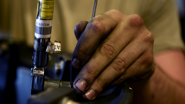 A photo of an Airman working working with tools.