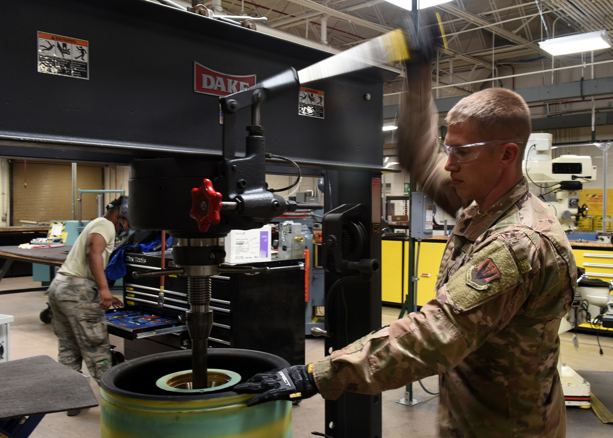 A photo of an Airman cranking a lever.