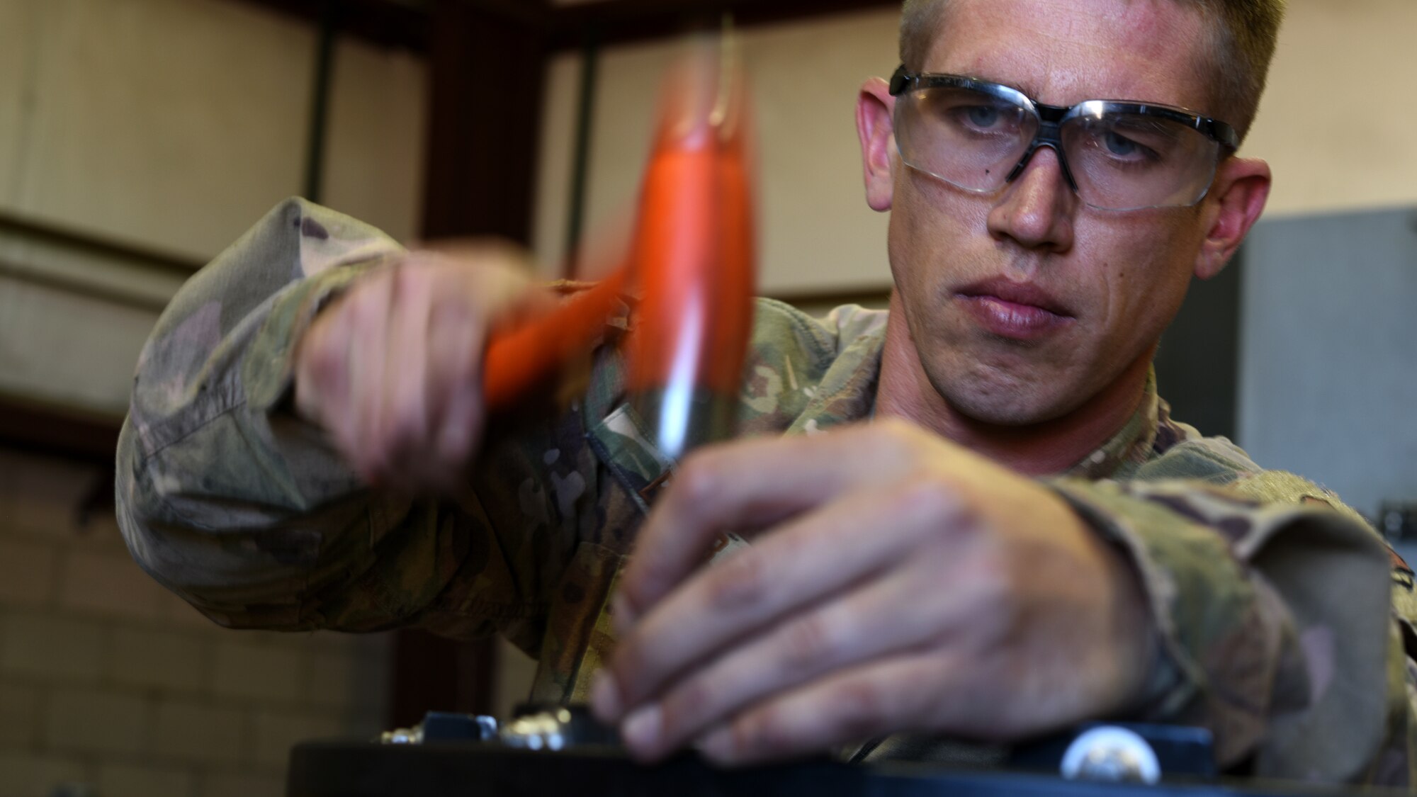 A photo of Airman working at a wheel and tire shop.