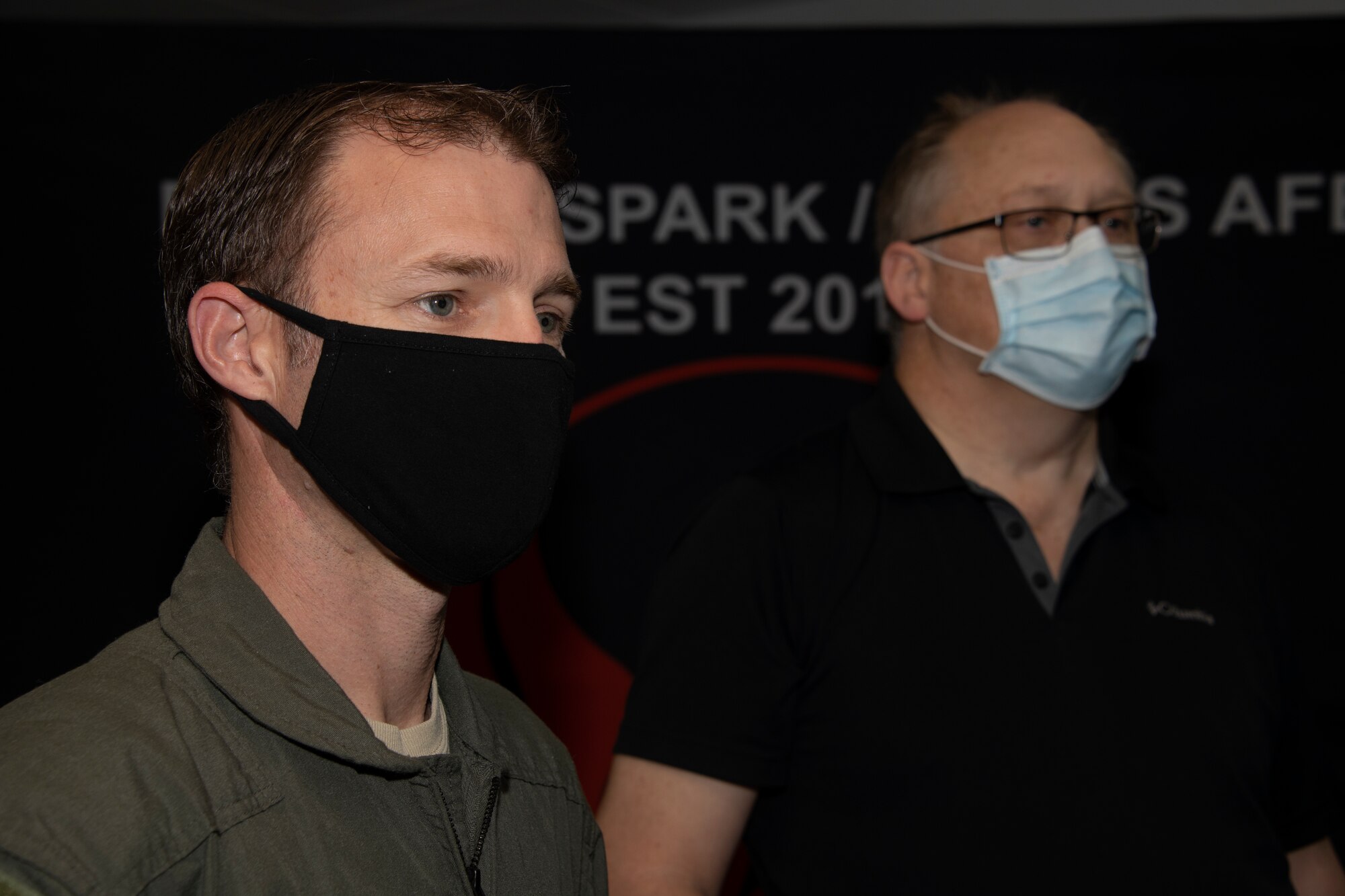 U.S. Air Force Senior Master Sgt. Phil Edwards, left, 60th Air Mobility Wing Phoenix Spark innovation cell superintendent, and John Dickerson, 60th AMW innovation officer, wear masks as they listen to a presentation May 20, 2020, during a commercial solutions offering event at Travis Air Force Base, California. The event, which featured 40 participants from 20 organizations, provided companies an opportunity to present innovative solutions to enhance the mission at Travis AFB. (U.S. Air Force photo by Tech. Sgt. James Hodgman)