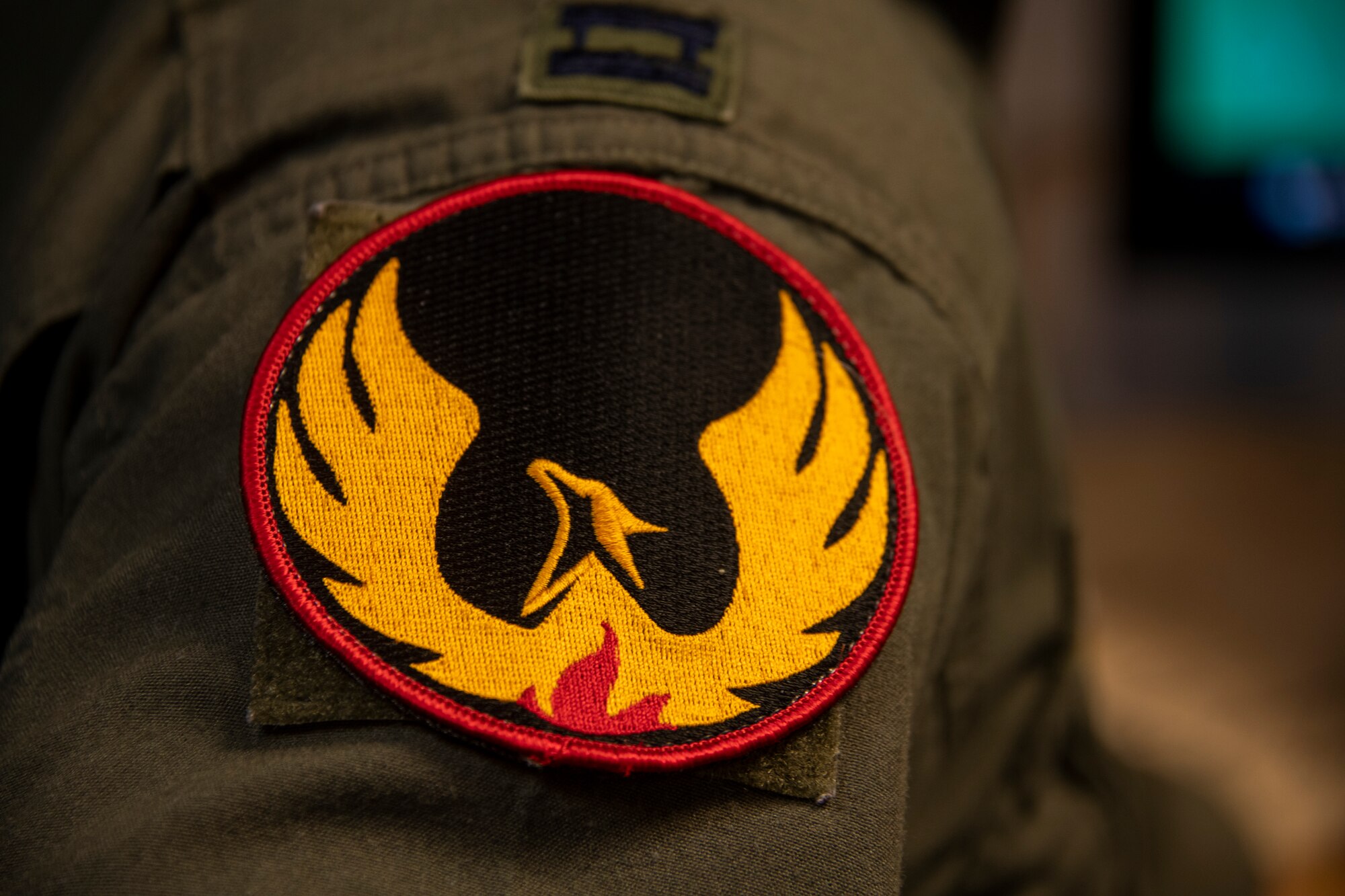 The 60th Air Mobility Wing Phoenix Spark innovation cell patch is attached to the right shoulder of U.S. Air Force Capt. Christopher Williston’s flight suit May 20, 2020, at Travis Air Force Base, California. Williston is a 21st Airlift Squadron C-17 Globemaster III pilot and the deputy chief of the innovation cell. He helped organize a commercial solutions offering event with the 60th Contracting Squadron so companies could provide innovate solutions to enhance the Travis AFB mission. (U.S. Air Force photo by Tech. Sgt. James Hodgman)