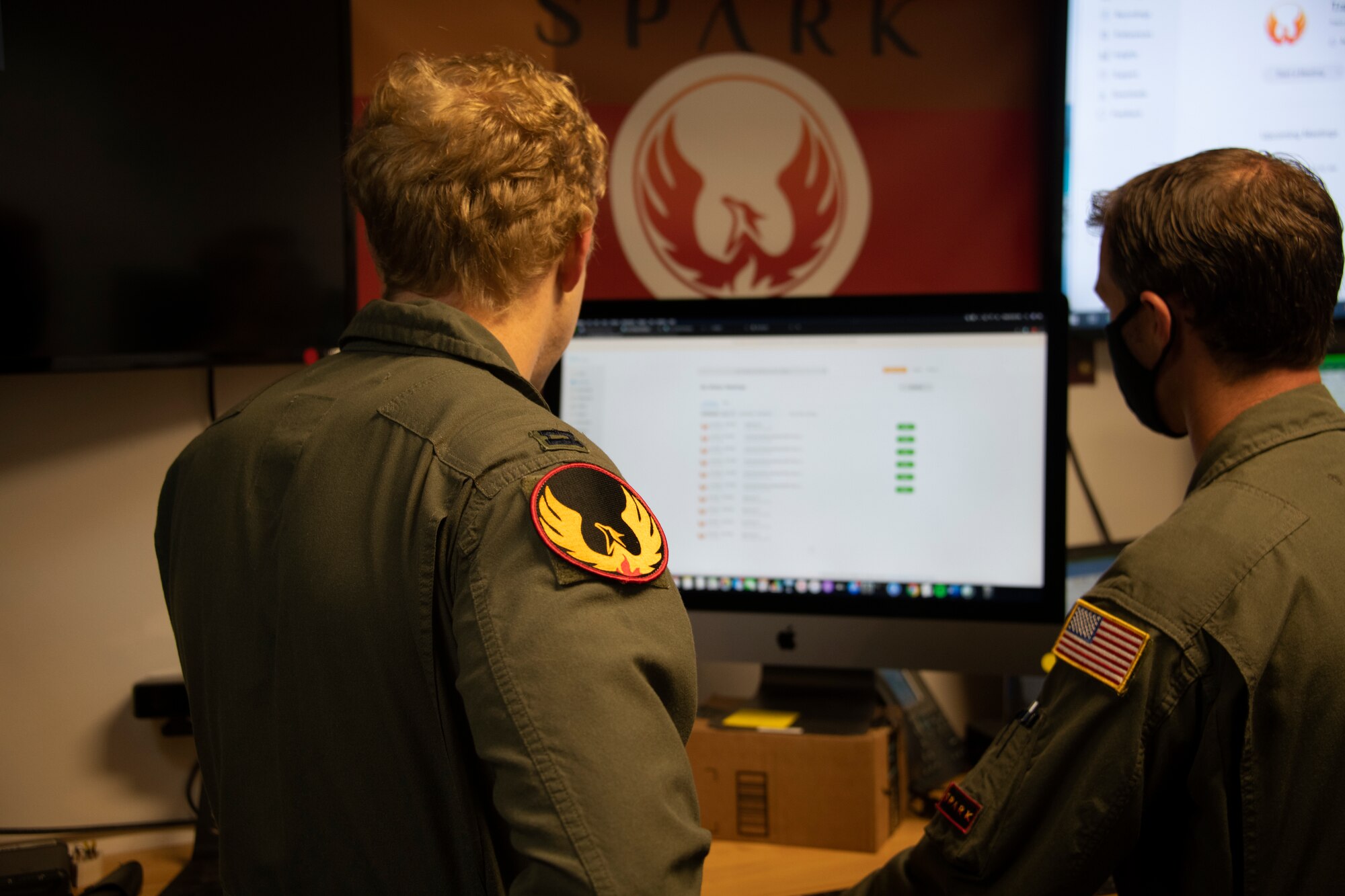 U.S. Air Force Capt. Christopher Williston, left, 21st Airlift Squadron C-17 Globemaster III pilot and the deputy chief of the 60th Air Mobility Wing Phoenix Spark innovation cell, and Senior Master Sgt. Phil Edwards, Phoenix Spark superintendent, prepare to listen to a presentation May 20, 2020, during a commercial solutions offering event at Travis Air Force Base, California. The event, which featured five companies, was organized by the innovation cell in partnership with the 60th Contracting Squadron. (U.S. Air Force photo by Tech. Sgt. James Hodgman)