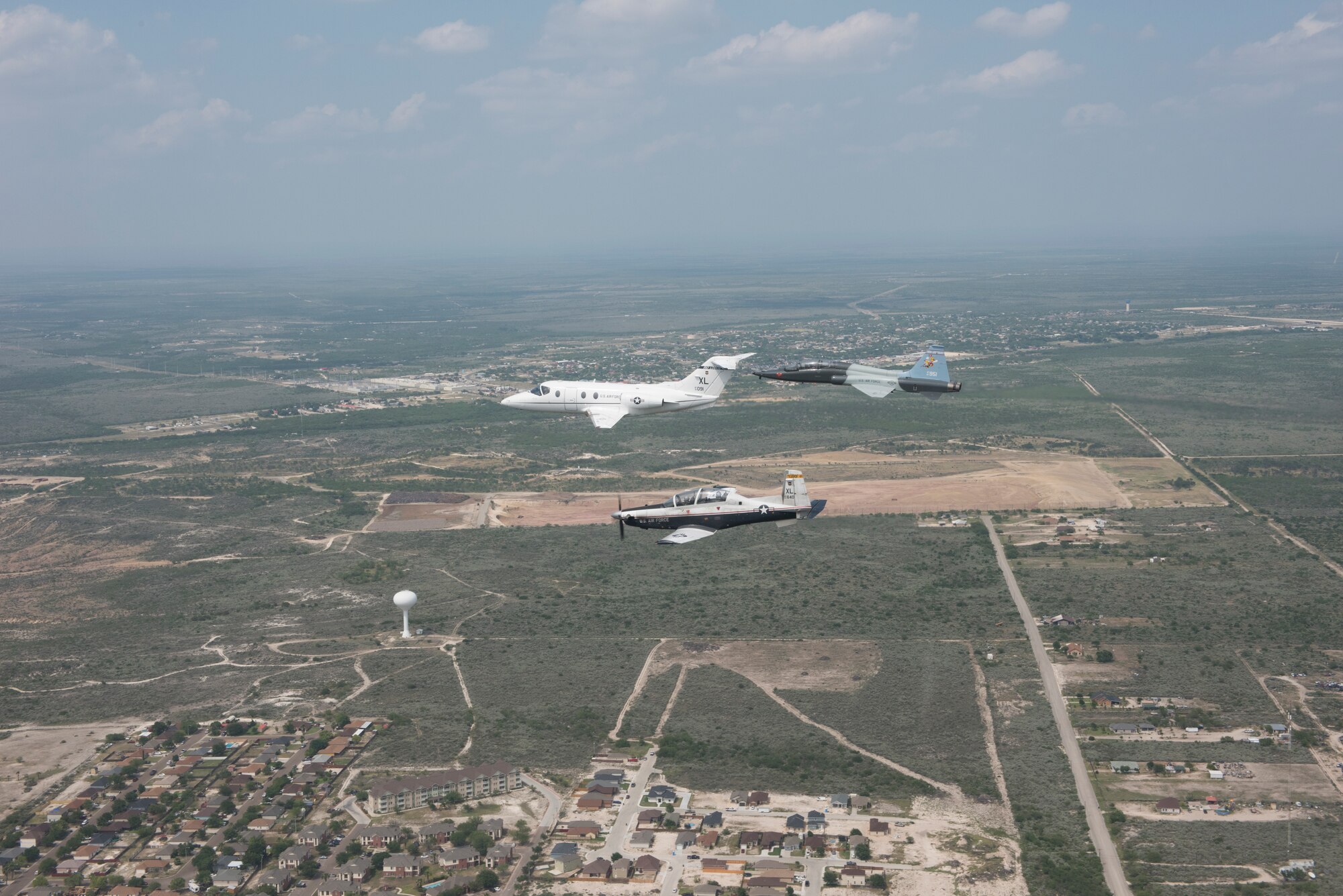 T-6 Texan II, T-1A Jayhawk and a T-38C Talon, assigned to Laughlin Air Force Base, Texas, perform a flyover in Del Rio, Texas, May 21, 2020. Laughlin performed flyovers in three Texas cities as a part of the America Strong America Salutes Campaign, to show its gratitude for all front-line responders, economy sustainers and community members in the COVID-19 pandemic. (U.S. Air Force photo by Master Sgt. JT May III)