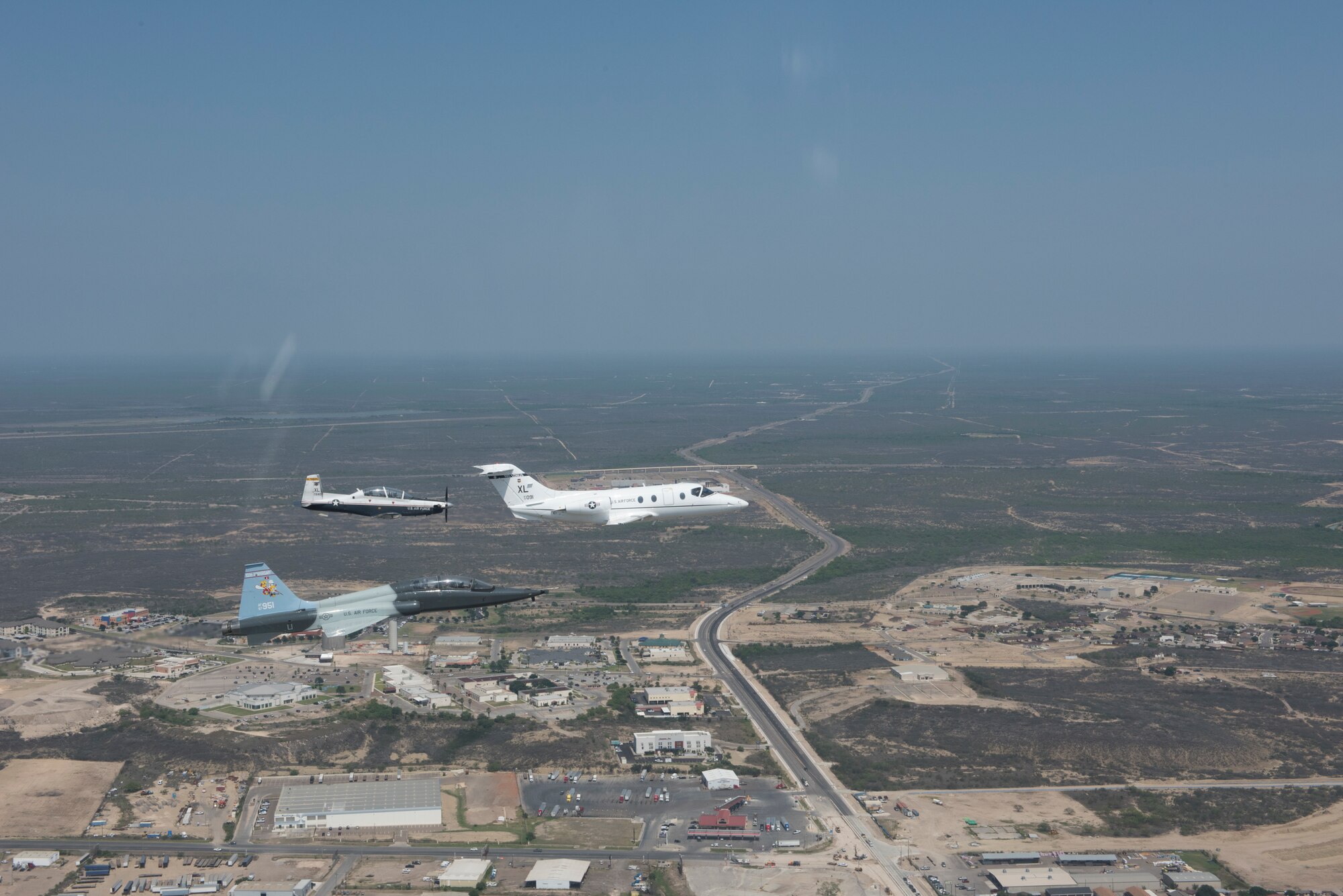 T-6 Texan II, T-1A Jayhawk and a T-38C Talon, assigned to Laughlin Air Force Base, Texas, perform a flyover in Eagle Pass, Texas, May 21, 2020. Laughlin performed flyovers in three Texas cities as a part of the America Strong America Salutes Campaign, to show its gratitude for all front-line responders, economy sustainers and community members in the COVID-19 pandemic. (U.S. Air Force photo by Master Sgt. JT May III)