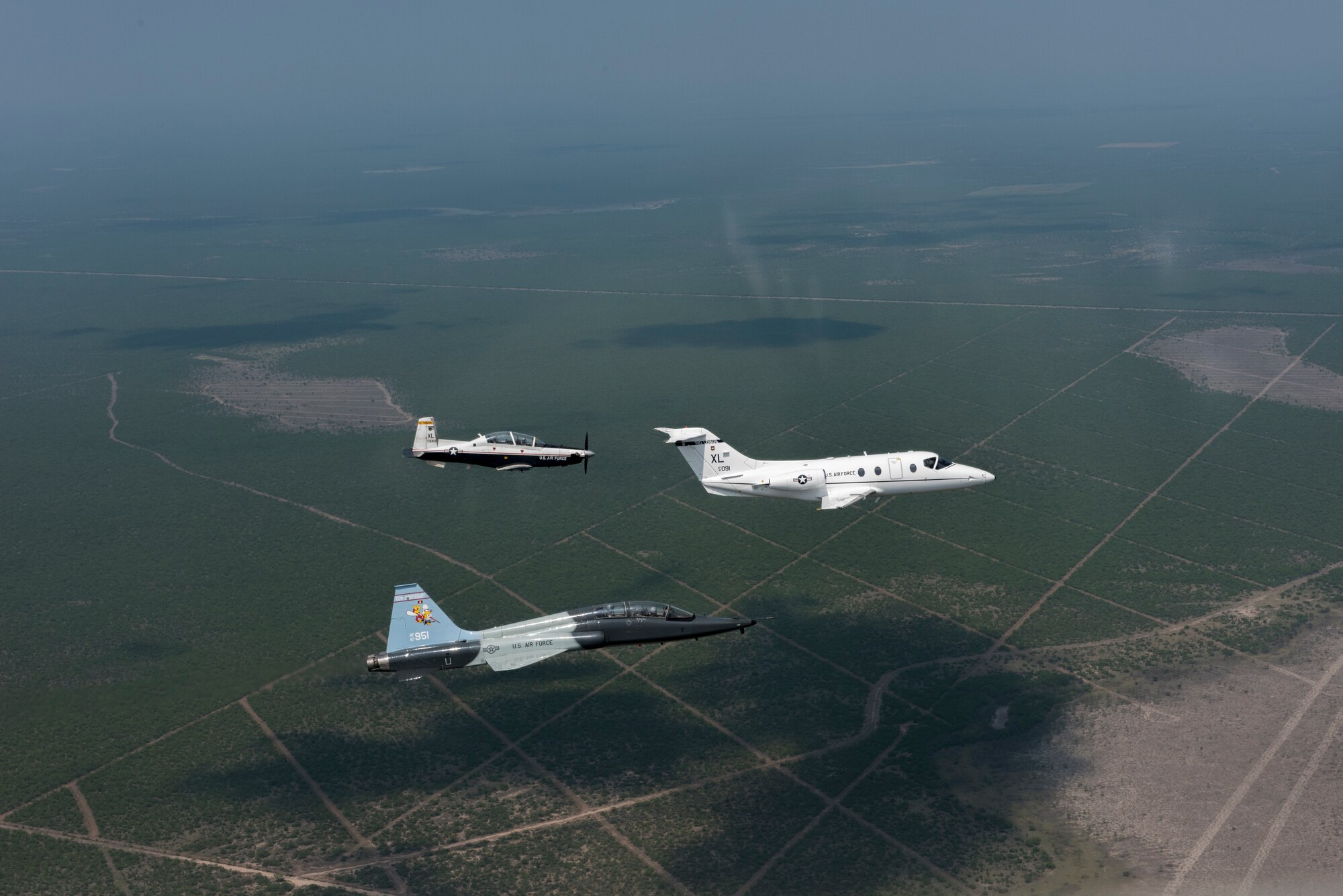 T-6 Texan II, T-1A Jayhawk and a T-38C Talon, assigned to Laughlin Air Force Base, Texas, perform a flyover in Eagle Pass, Texas, May 21, 2020. Laughlin performed flyovers in three Texas cities as a part of the America Strong America Salutes Campaign, to show its gratitude for all front-line responders, economy sustainers and community members in the COVID-19 pandemic. (U.S. Air Force photo by Master Sgt. JT May III)