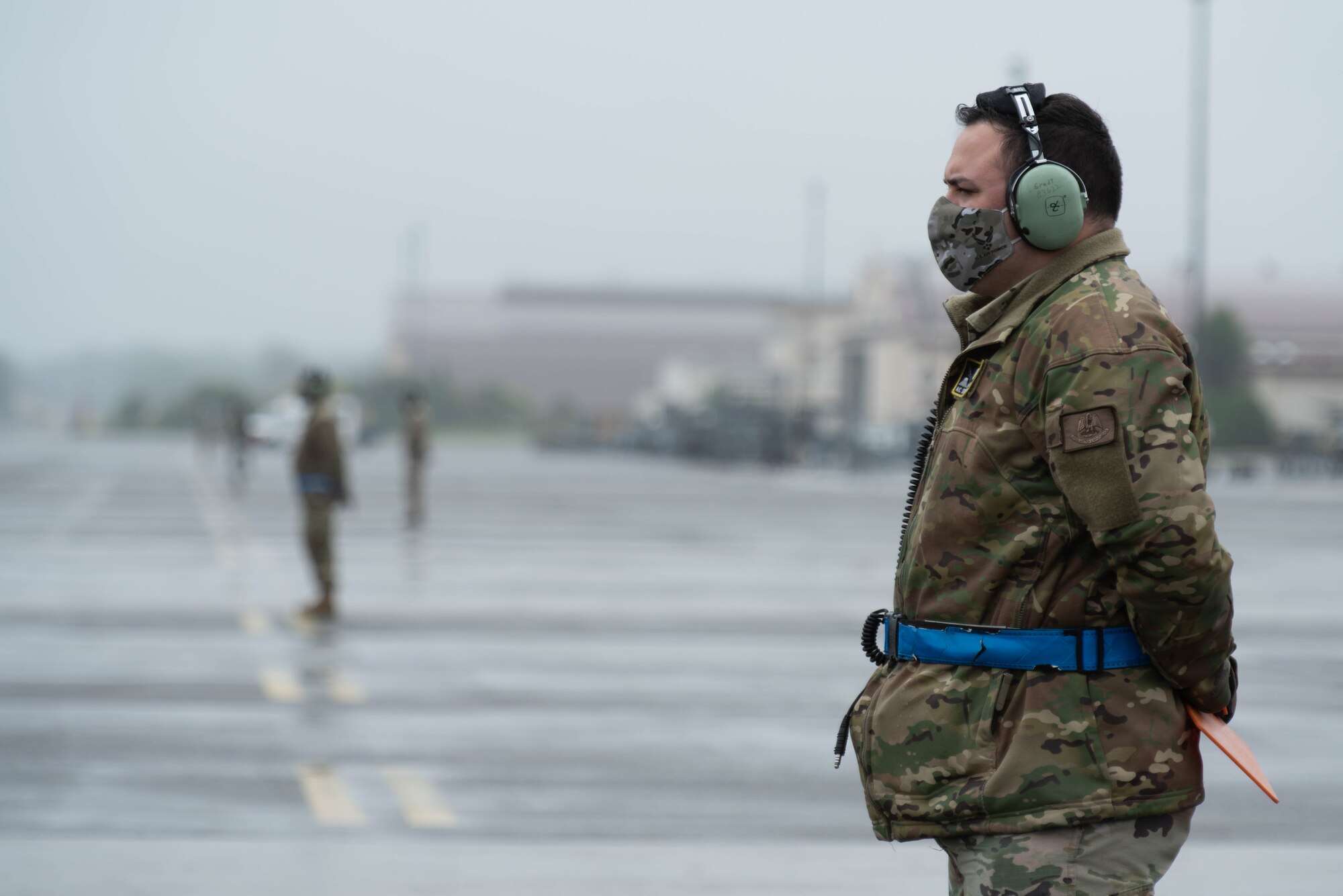 A crew chief assigned to the 374th Aircraft Maintenance Squadron prepares to marshal C-130J Super Hercules during the 374th Airlift Wing’s Samurai Surge training exercise, May 21, 2020, at Yokota Air Base, Japan.