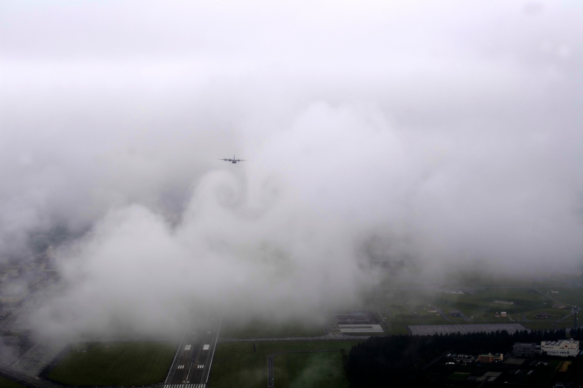 A C-130J Super Hercules, assigned to the 36th Airlift Squadron, flys through the clouds above the Yokota Air Base, Japan, flightline during the formation flight portion of the Samurai Surge training exercise, May 21, 2020.