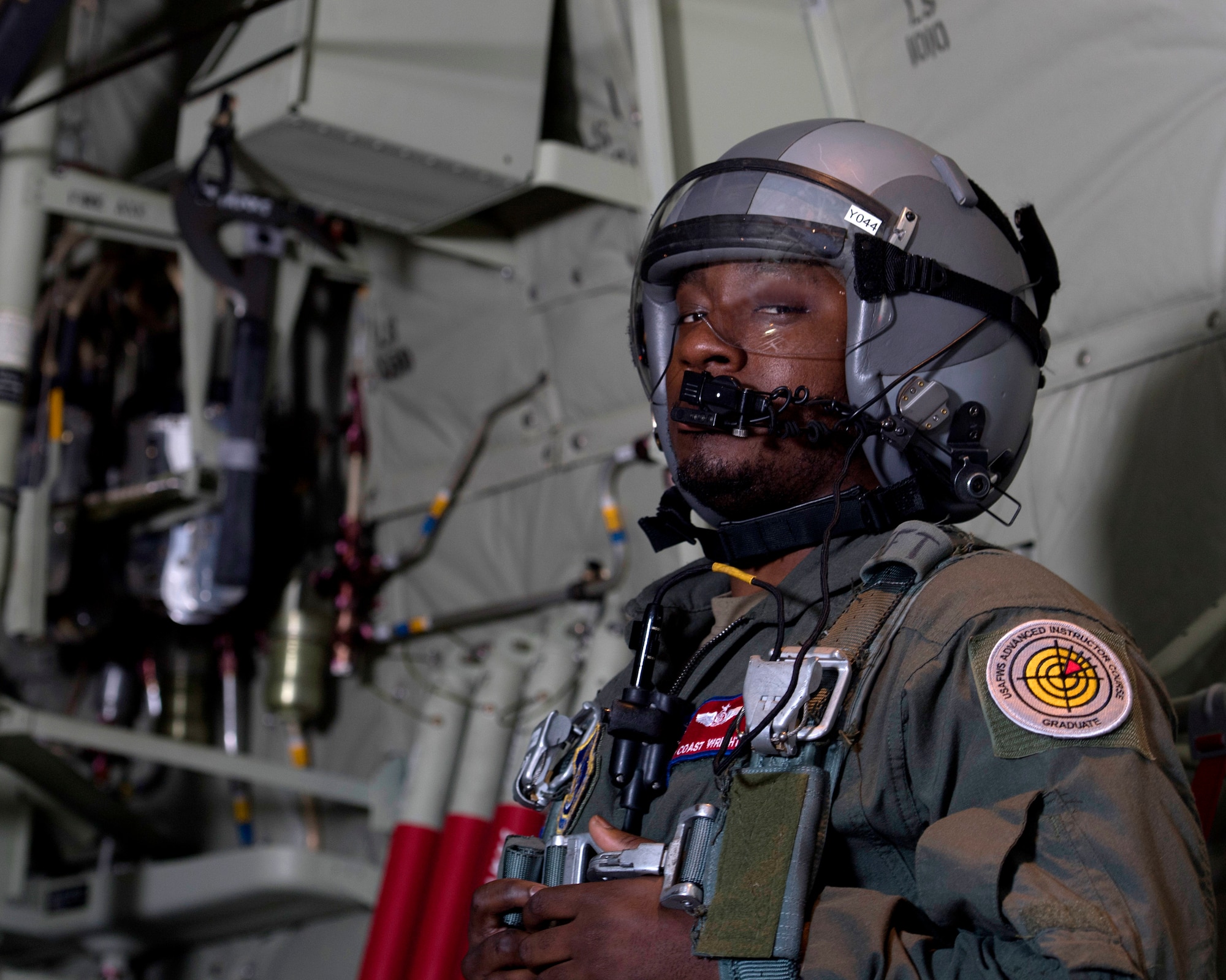 Staff Sgt. Marcus Wright, 36th Airlift Squadron C-130J Super Hercules loadmaster, briefly looks at the camera before opening the door to get formation flight documentation during Yokota Air Base, Japan’s Samurai Surge training exercise, May 21, 2020.