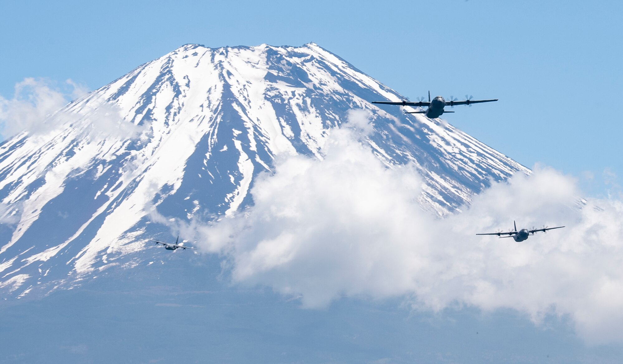 Three C-130J Super Hercules' assigned to the 36th Airlift Squadron fly over Mount Fuji, May 11, 2020, during a pre-Samurai Surge training exercise.