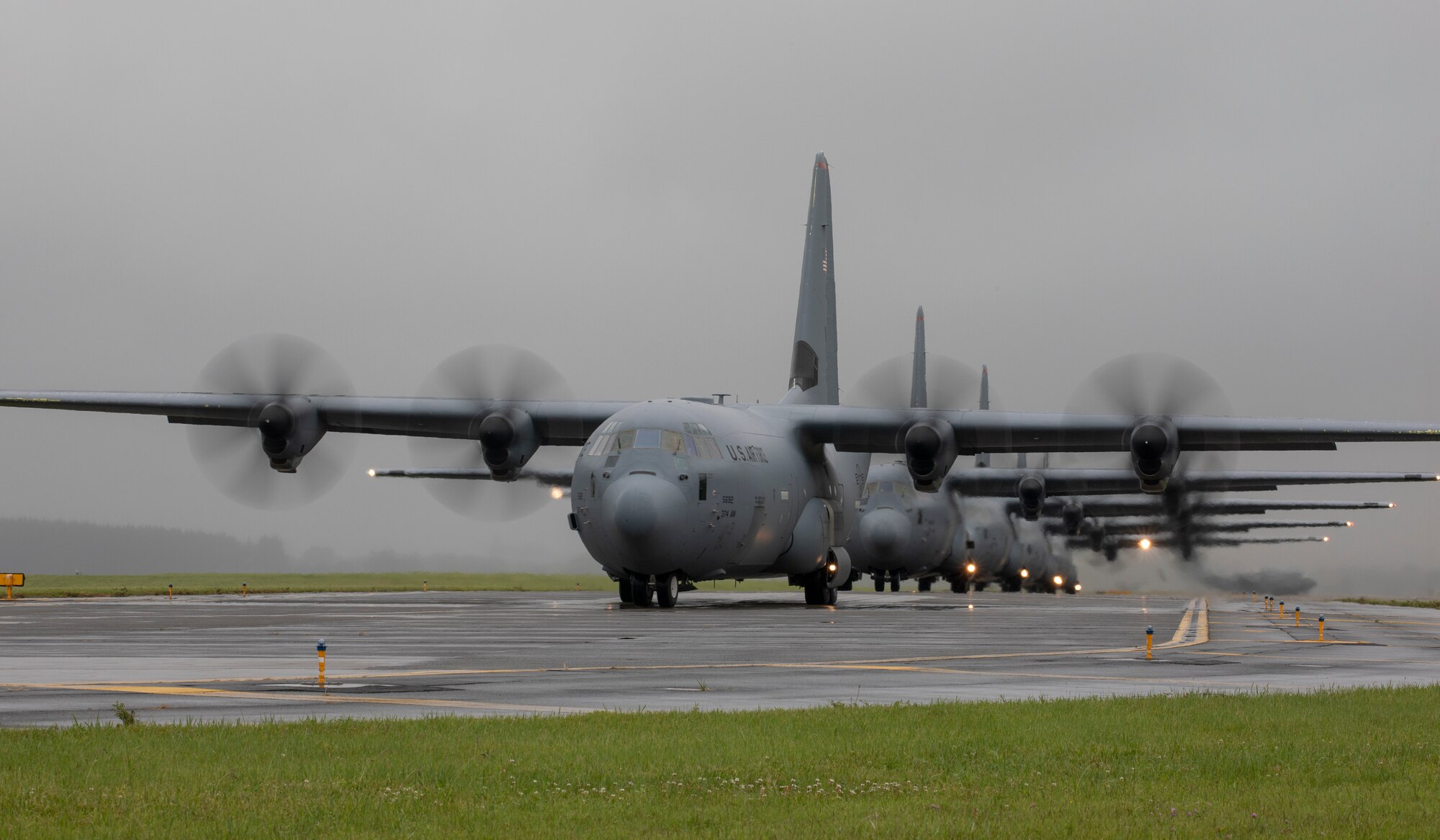 Seven C-130J Super Hercules aircraft from the 374th Airlift Wing fly line up on the flightline as part of the elephant walk portion of the Samurai Surge training exercise at Yokota Air Base, Japan, May 21, 2020.