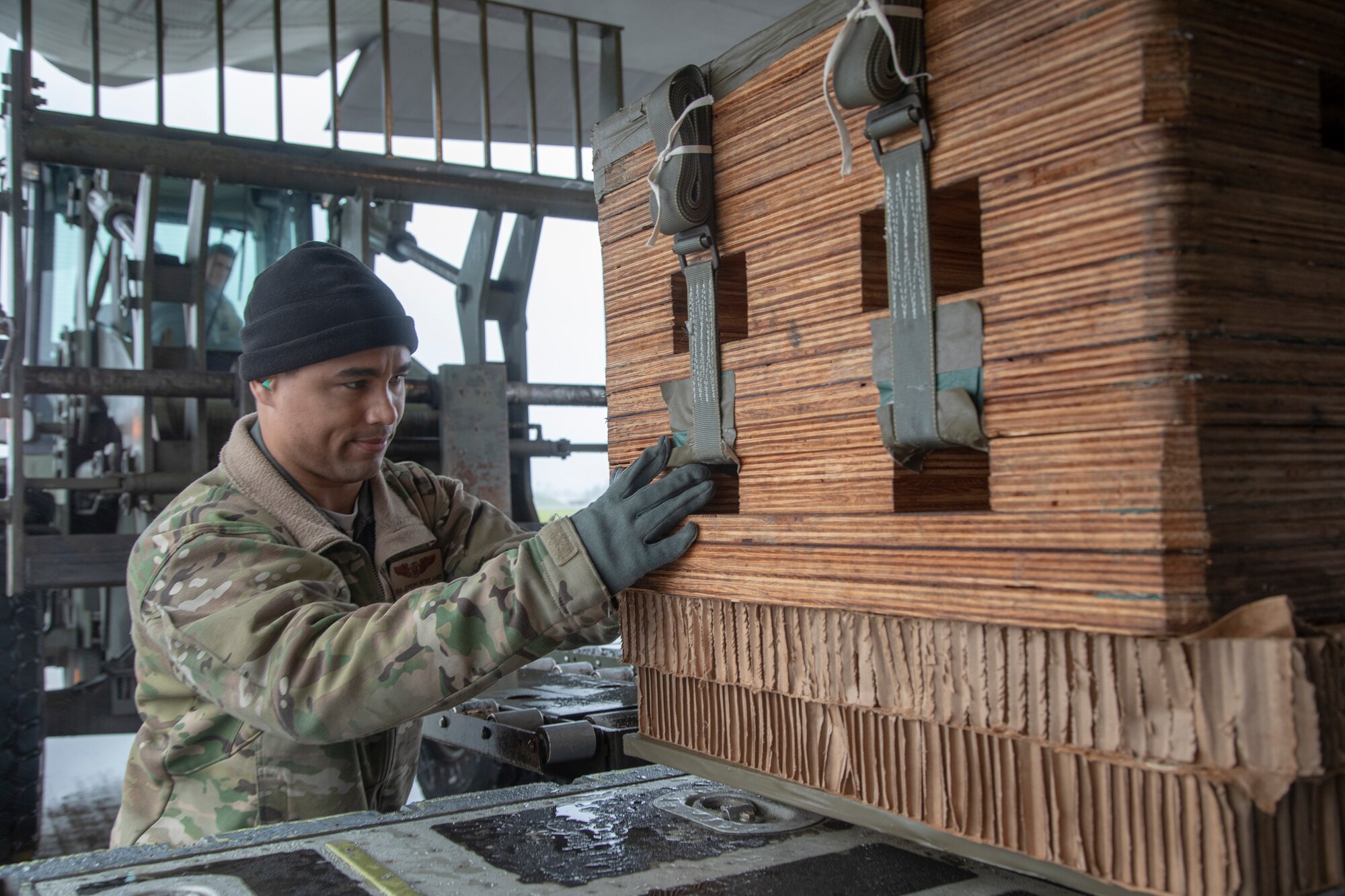 A loadmaster with the 36th Airlift Squadron loads a low-cost, low-altitude bundle onto a C-130J Super Hercules at Yokota Air Base, Japan, May 21, 2020, during the Samurai Surge training exercise.