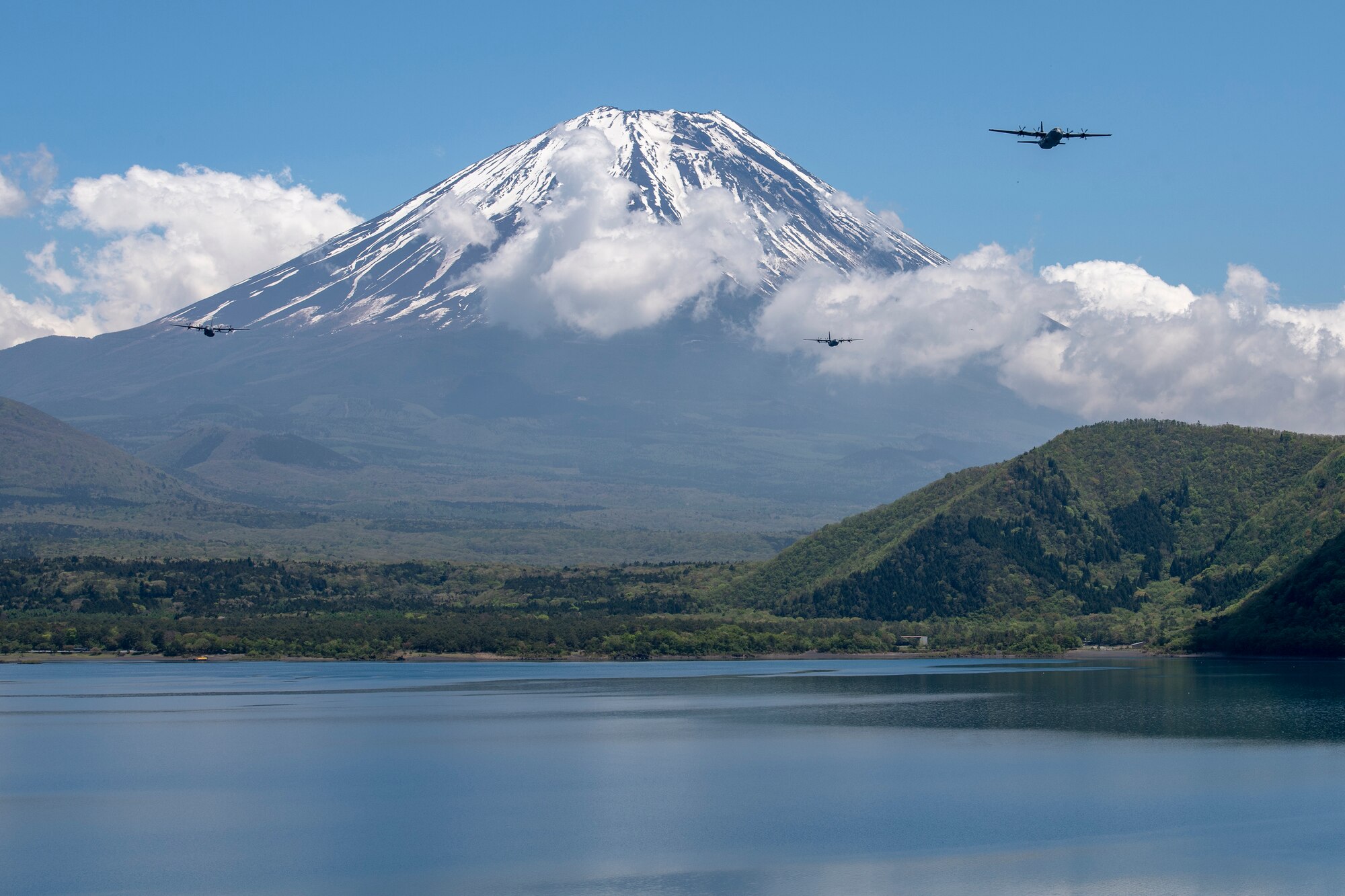 Three C-130J Super Hercules' assigned to the 36th Airlift Squadron fly over Lake Motosu, May 11, 2020, during a pre-Samurai Surge training exercise.