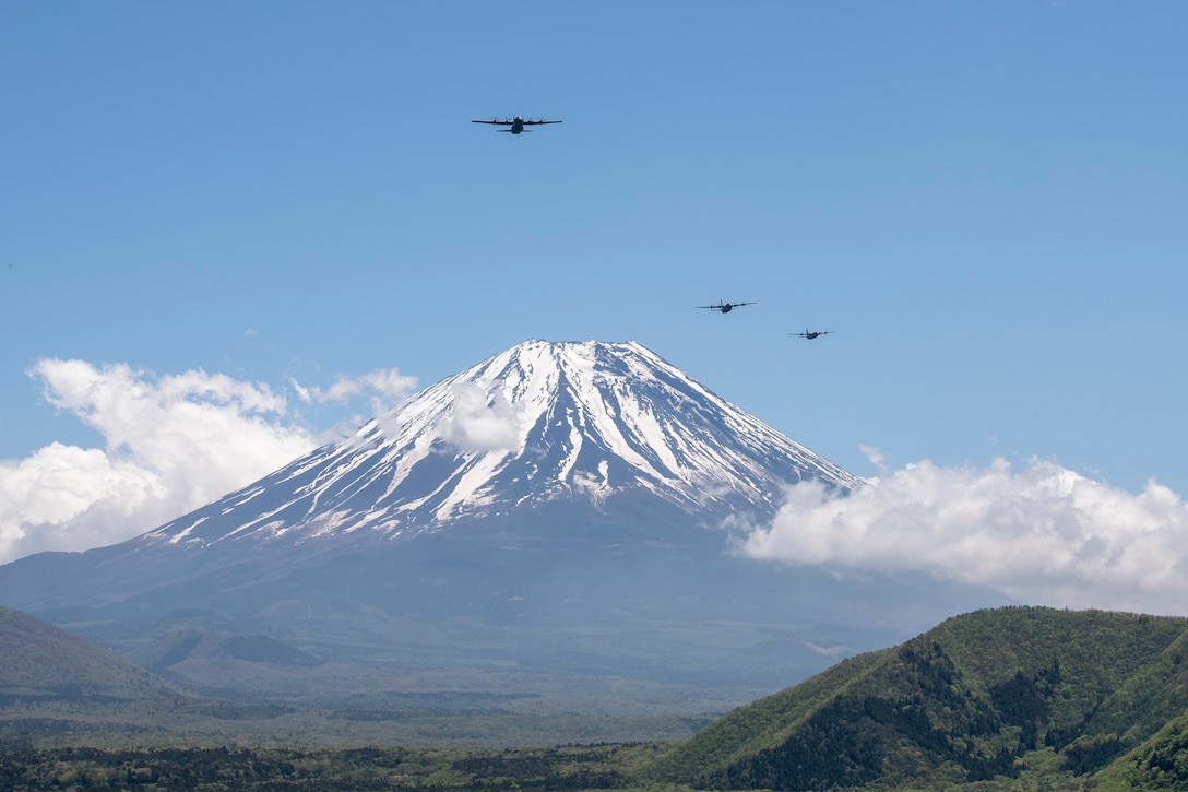 Three C-130J Super Hercules' assigned to the 36th Airlift Squadron fly over Mount Fuji, May 11, 2020, during a pre-Samurai Surge training exercise.
