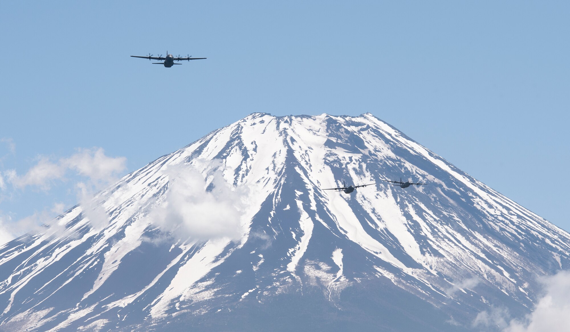 Three C-130J Super Hercules' assigned to the 36th Airlift Squadron fly over Mount Fuji, May 11, 2020, during a pre-Samurai Surge training exercise.