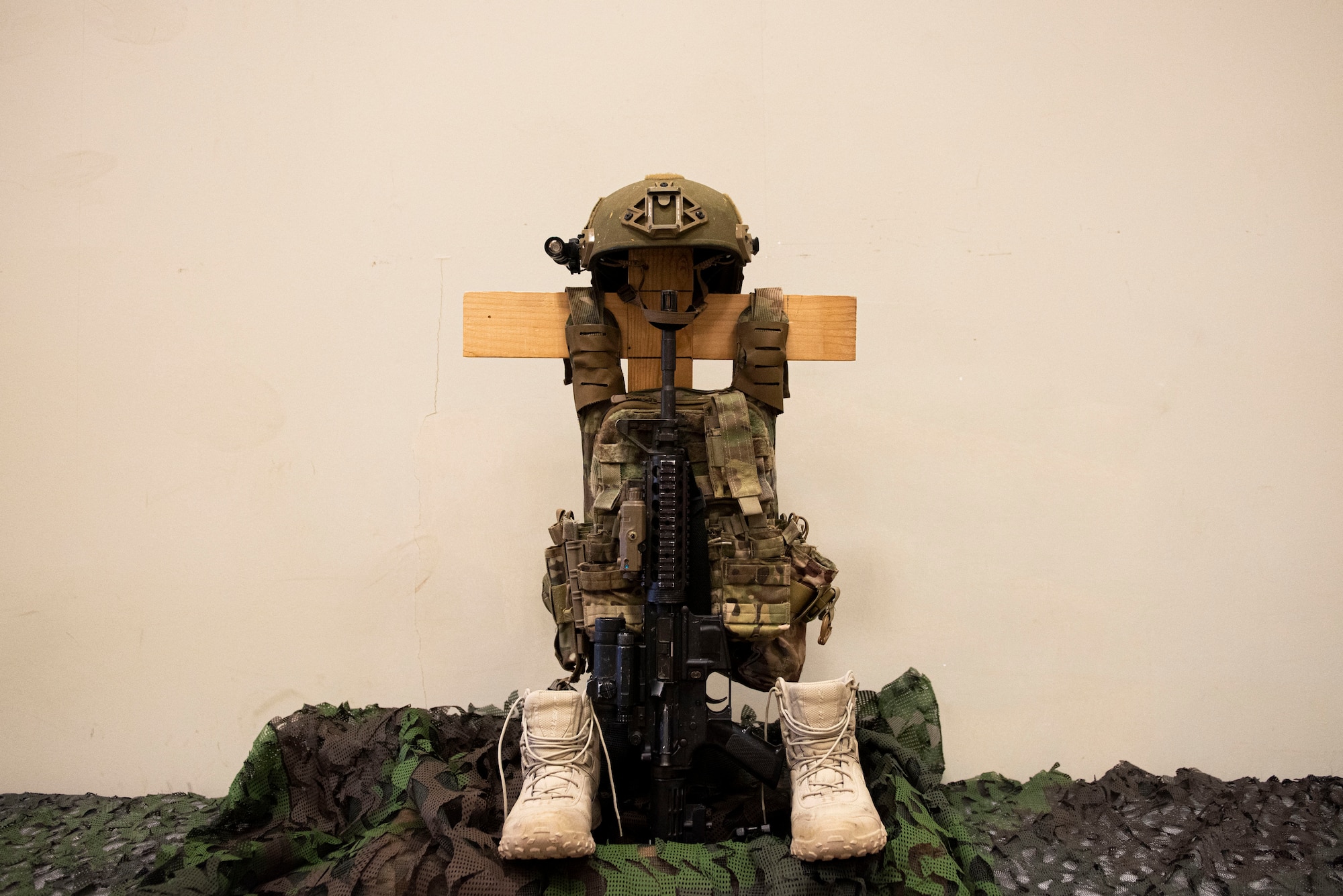 A battlefield cross sits on display during a Final Guard Mount ceremony May 15, 2020, at Incirlik Air Base, Turkey. The battlefield cross is a memorial which commemorates fallen troops, featuring a rifle, helmet and empty pair of boots. (U.S. Air Force photo by Staff Sgt. Joshua Magbanua)
