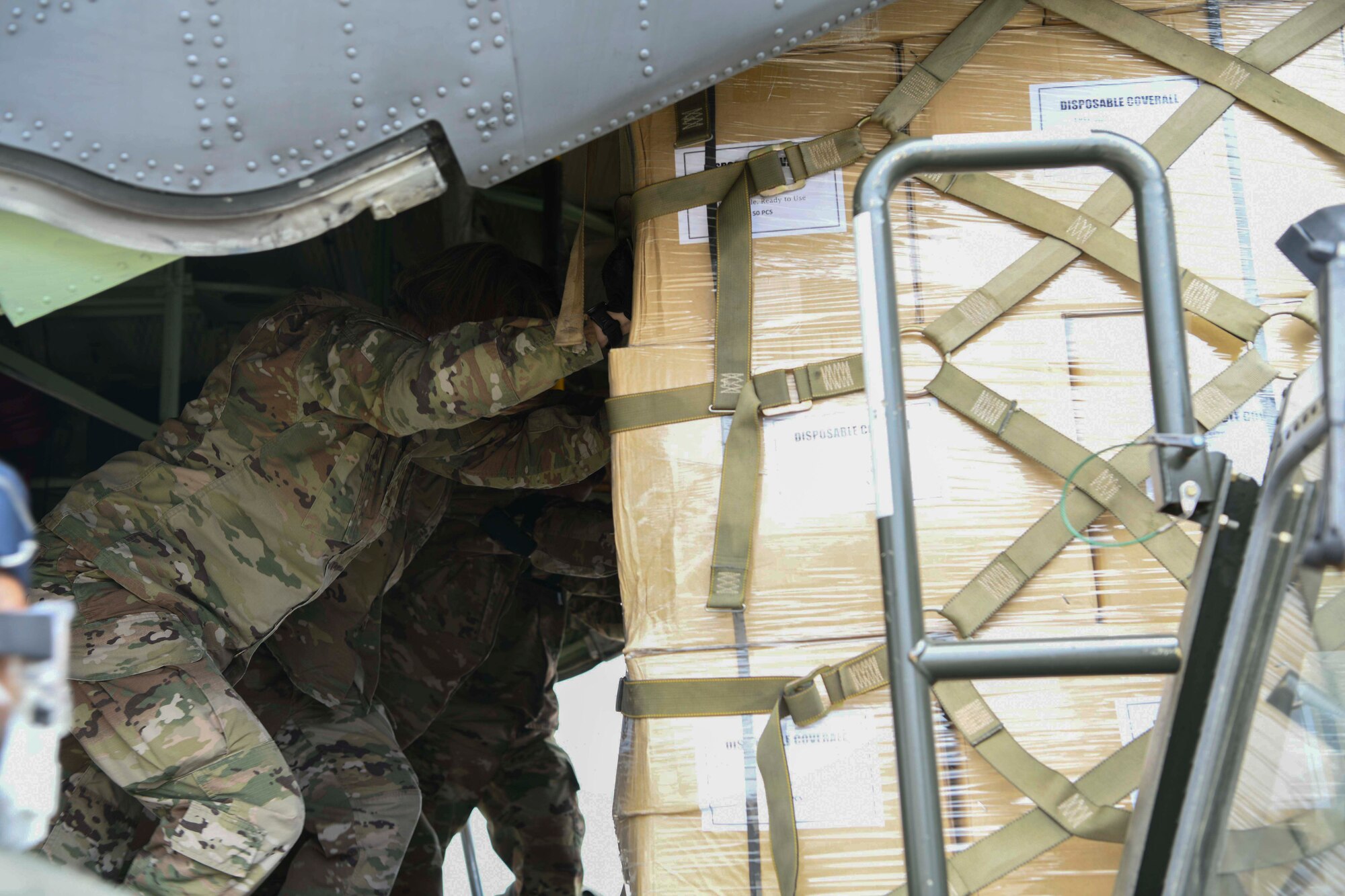 89th Airlift Wing Airmen unload a Pakistan air force C-130 aircraft at Joint Base Andrews, Md., May 21, 2020. Airmen assigned to the 89th Airlift Wing and Pakistani aircrew offloaded the donated protective masks and coveralls from the aircraft. (U.S. Air Force photo by Airman 1st Class Spencer Slocum)