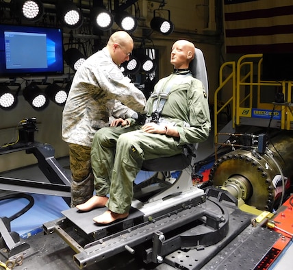 Master Sgt. James Chase of the AFRL 711th Human Performance Wing Biodynamics team prepares an instrumented 250-pound test device, simulating a human occupant, for seat testing on the Horizontal Impulse Accelerator, located at Wright-Patterson Air Force Base. The test is one of a series recently conducted to support the acceptance and implementation of the Portable Biocontainment Care Module, which will aid in the safe transport of personnel affected by infectious diseases, including COVID-19. (Photo courtesy of Infoscitex Corporation/Christopher Albery)