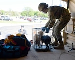 Pfc. Lydia Humphrey, 1073rd Maintenance Company, Michigan Army National Guard, assists Anita Wheeler from Midland, Michigan, as the Guard responds to flooding caused by dam breaches May 20, 2020. Michigan National Guard units from Bay City, Saginaw, Port Huron and other nearby communities helped evacuate people.