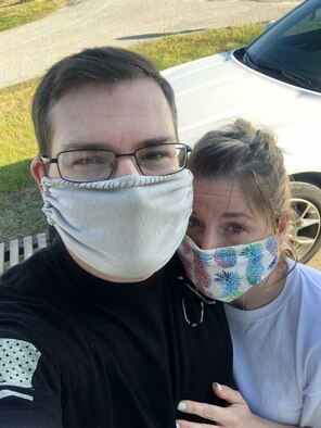 Staff Sgt. Christopher Boyd, 66th Air Base Group unit deployment manager and his wife, Michelle, smile behind homemade facial coverings at their home outside Hanscom Air Force Base, Mass., May 21. The Boyds have been making facial coverings to include filters and nose guards, and delivering them to members in their community. (Courtesy Photo)