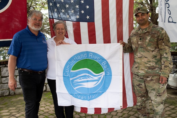 Lt. Col. Sonny B. Avichal, U.S. Army Corps of Engineers Nashville District commander, presents the “Clean Marina” flag to John and Natasha Deane, owners of Wildwood Resort and Marina, during a dedication May 21, 2020 at the resort located at Cordell Hull Lake in Granville, Tennessee.  The event recognized the marina’s voluntary efforts to reduce water pollution and erosion in the Cumberland River watershed, and for promoting environmentally responsible marina and boating practices. (USACE photo by Lee Roberts)